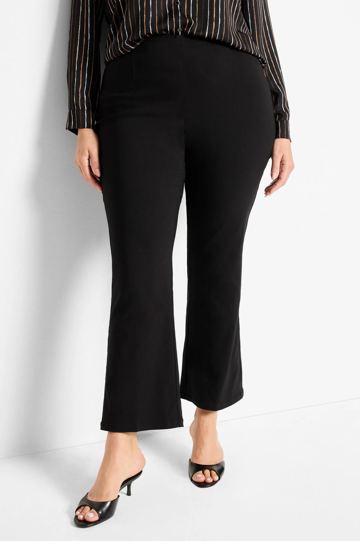 Black bootcut pants with a slight flare at the ankle. Smooth, black fabric.