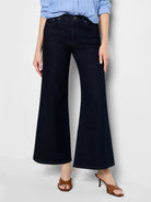 Dark indigo, high-waisted boot flare jeans with a wide leg.