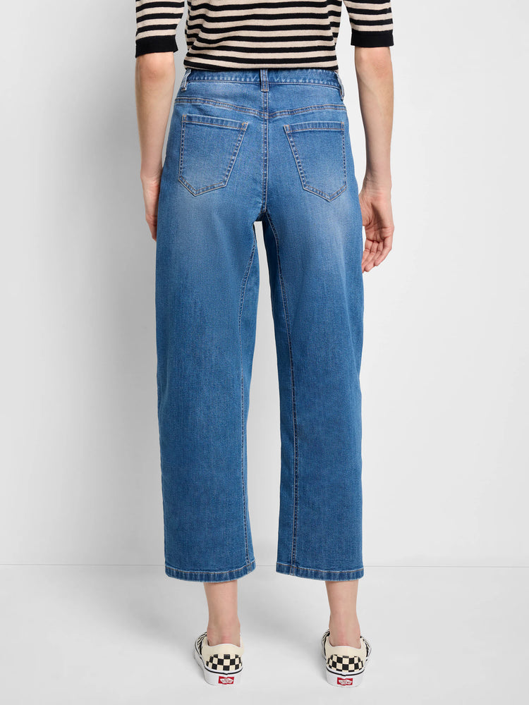 Medium blue barrel leg jeans with a relaxed, wide, cropped fit. Visible back pockets and subtle fading.