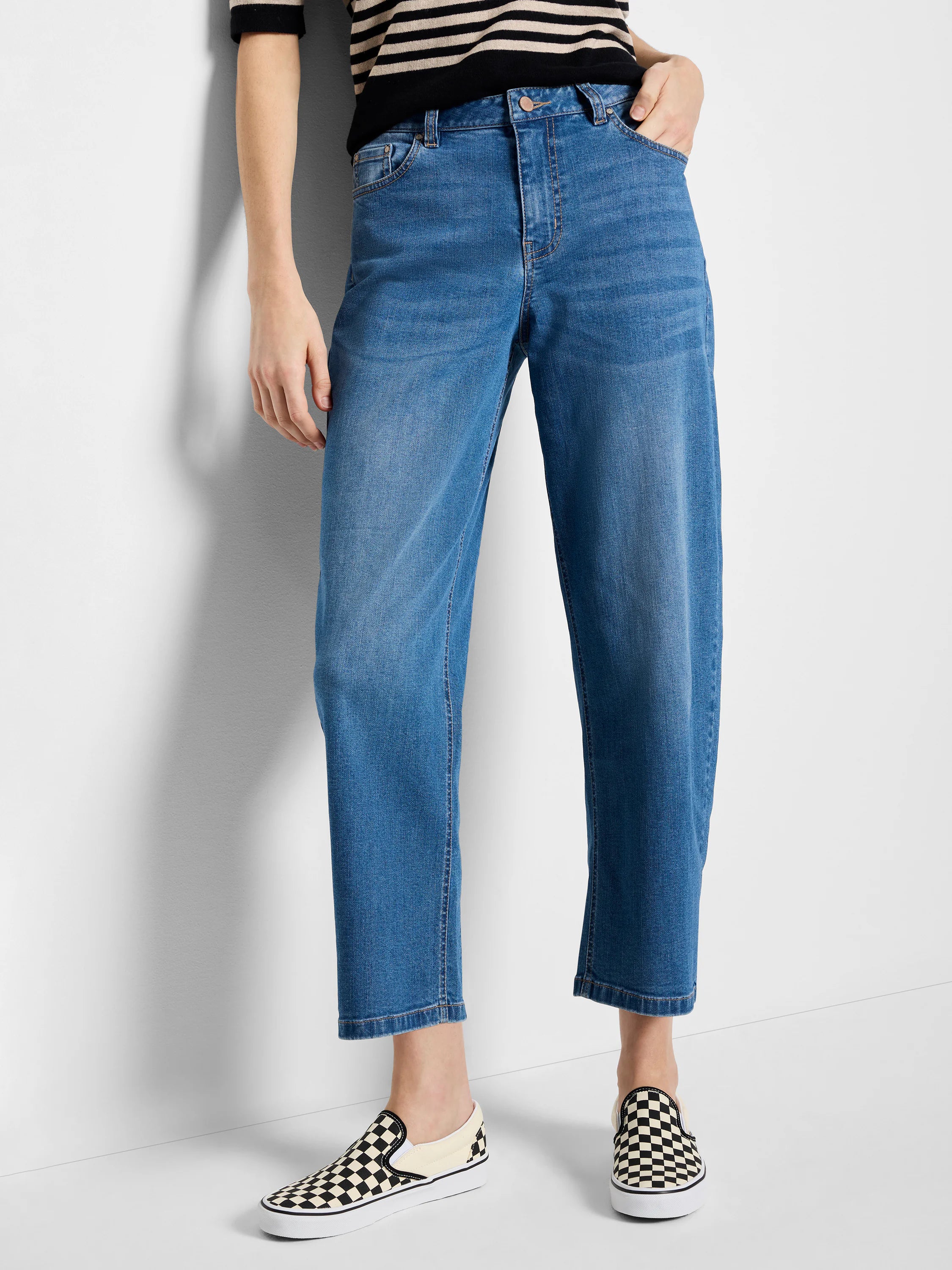 Medium blue denim barrel leg jeans, high-waisted, with a wide thigh, slight taper, and cropped above the ankle.