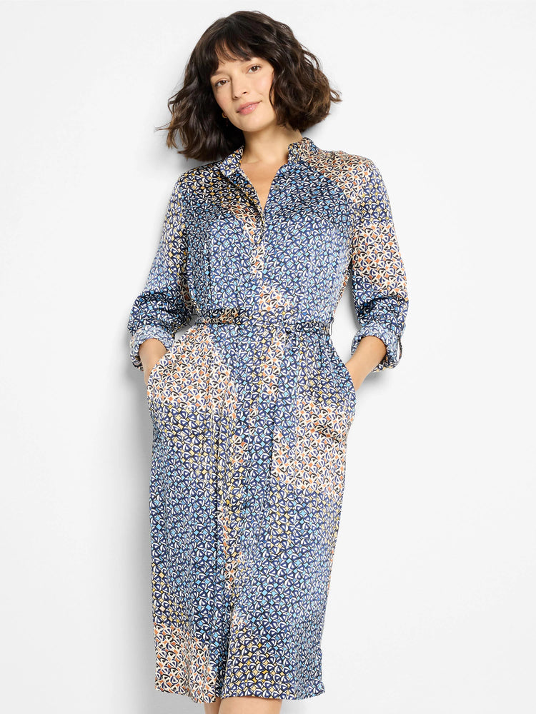 Midi-length shirt dress, belted, with blue, beige, and white geometric print. Three-quarter sleeves, collared. Has pockets.