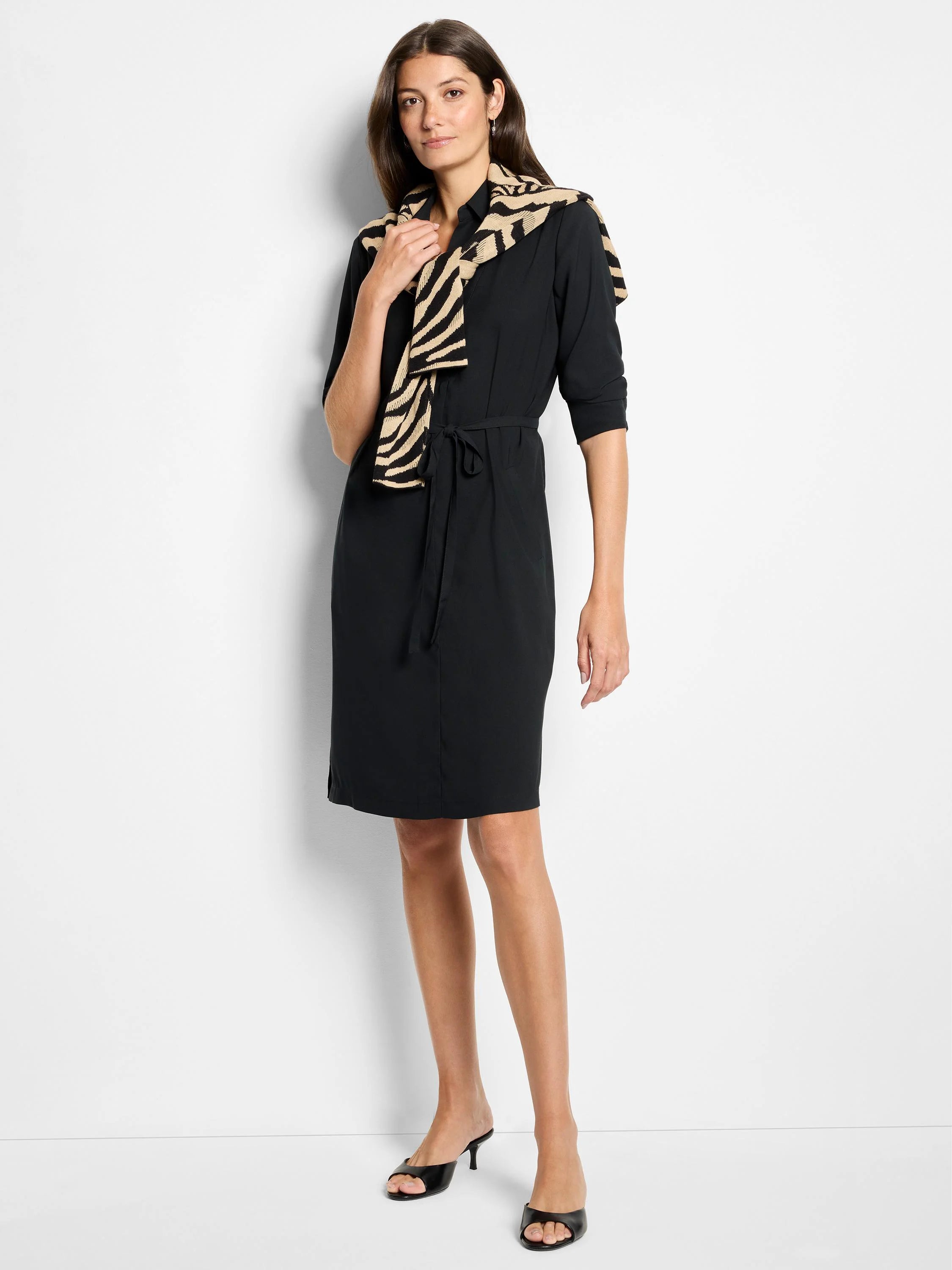 Black long-sleeve knee-length dress with a self-tie belt. Features a zebra-print scarf.