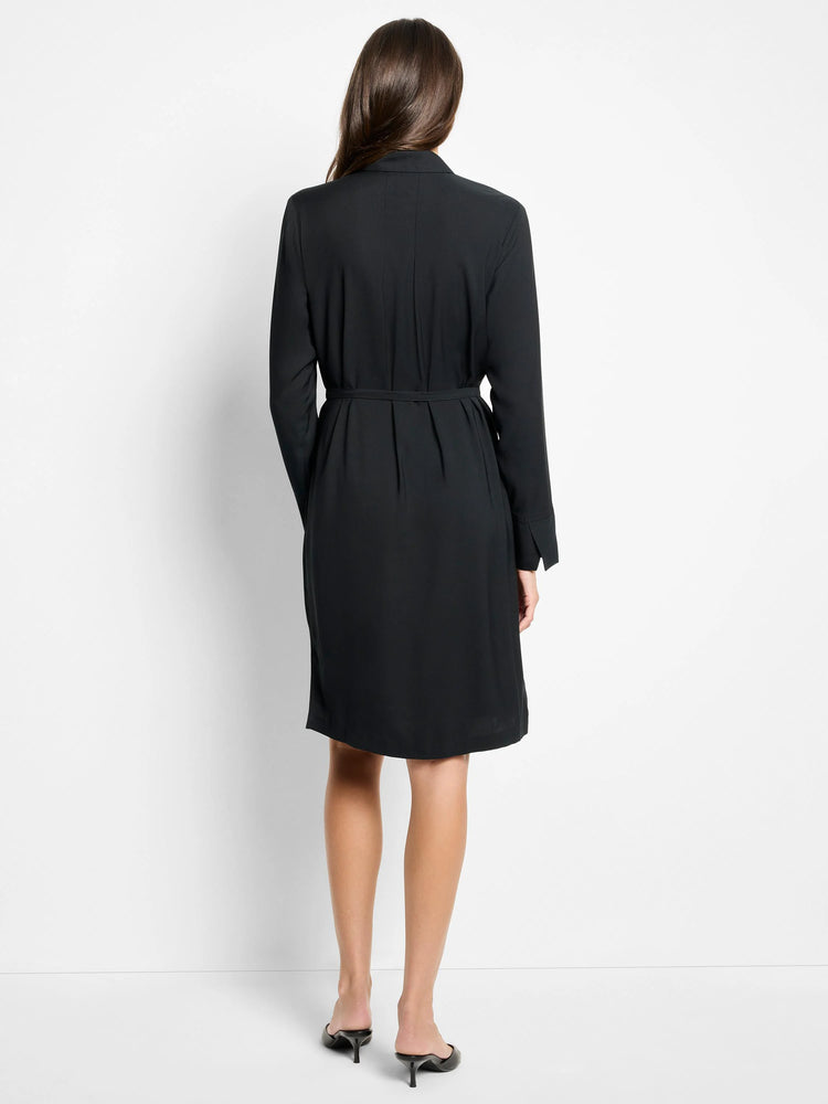 Black long-sleeved mini dress with a belted waist. Back view.