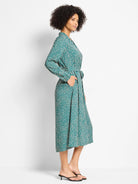 Teal midi dress with cream shadow dots, long sleeves, collar, self-tie waist, and pockets.