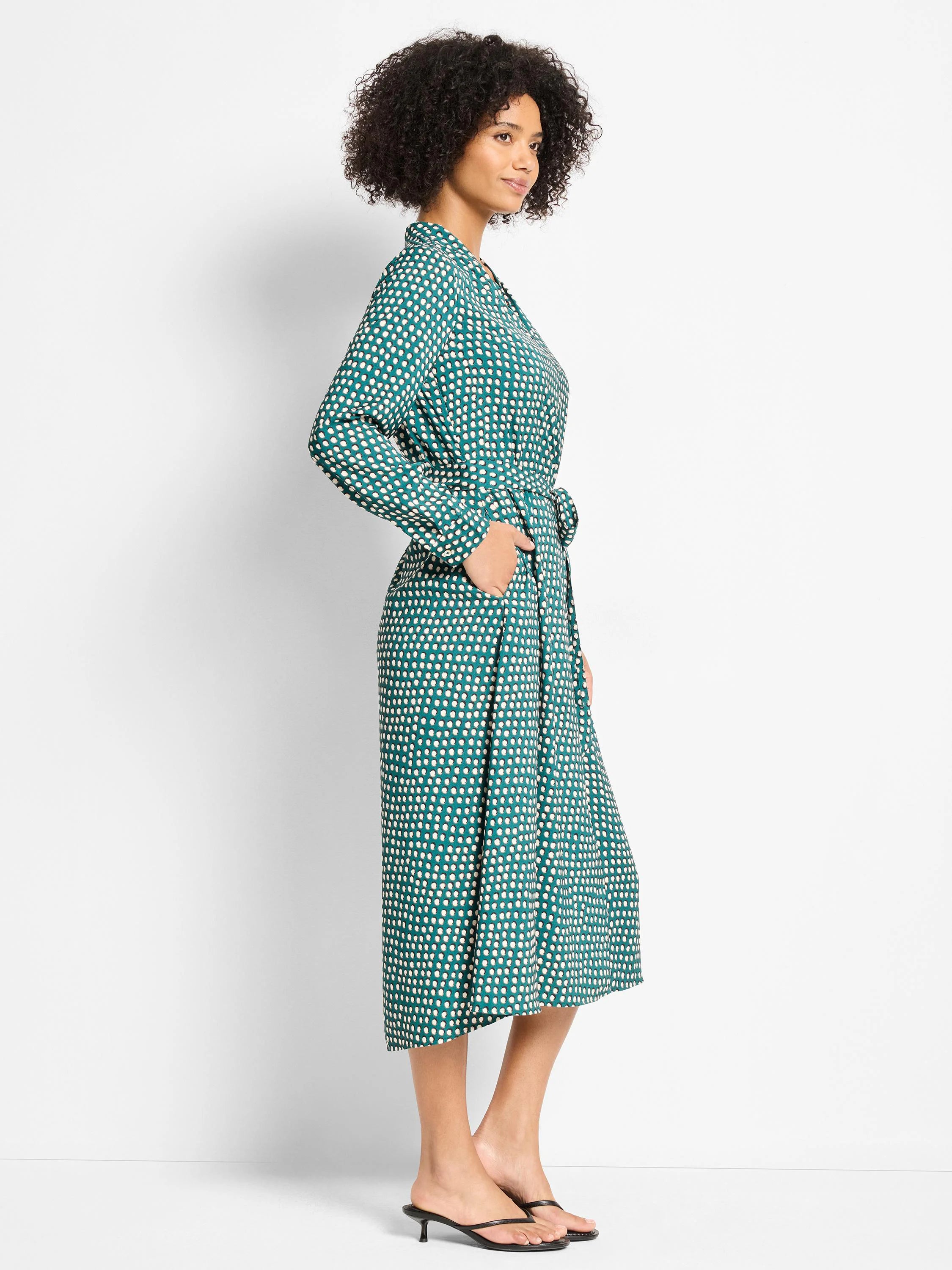 Teal midi dress with cream shadow dots, long sleeves, collar, self-tie waist, and pockets.