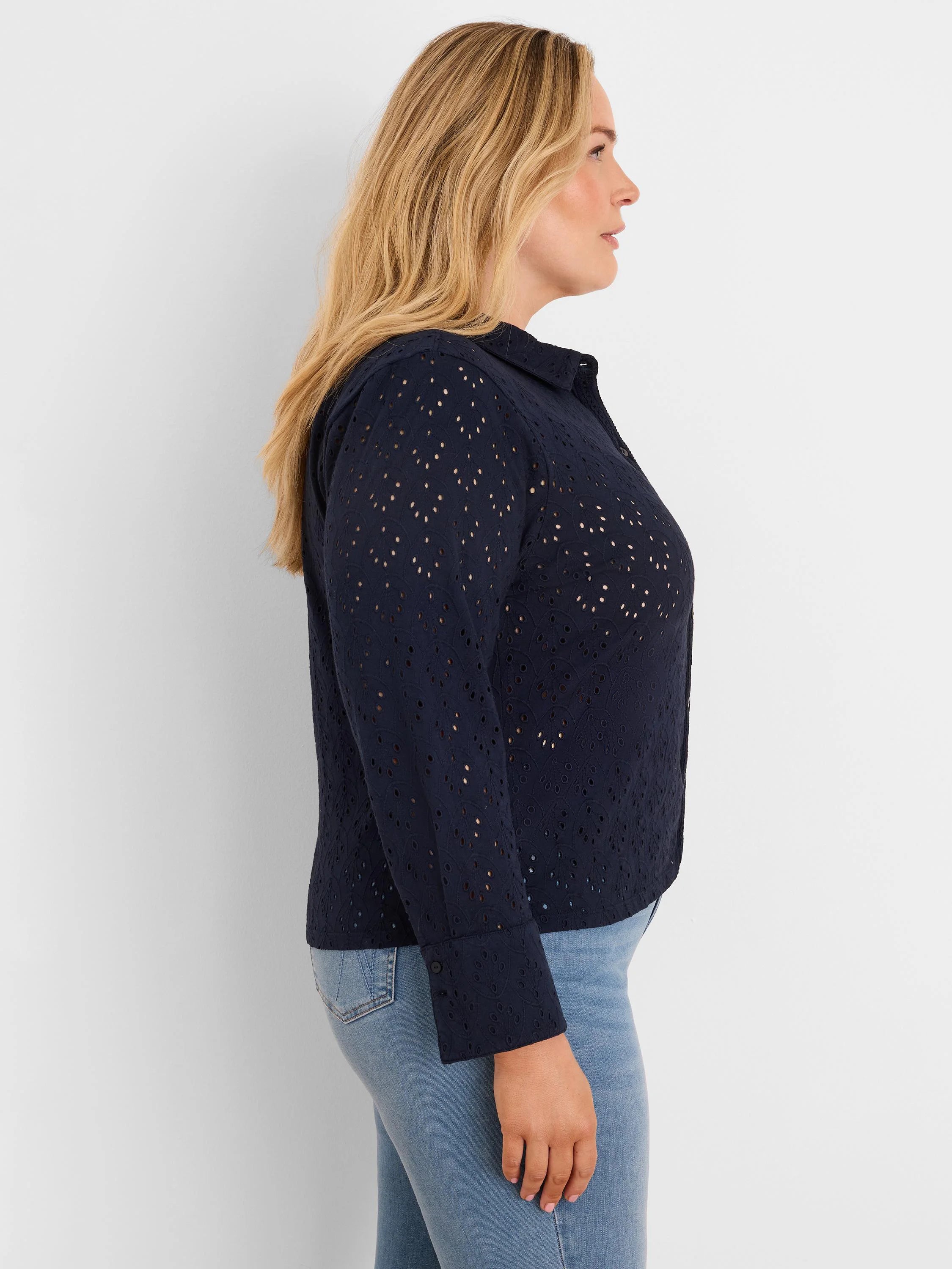 Navy blue eyelet knit top with collar and long sleeves, featuring small cutouts.