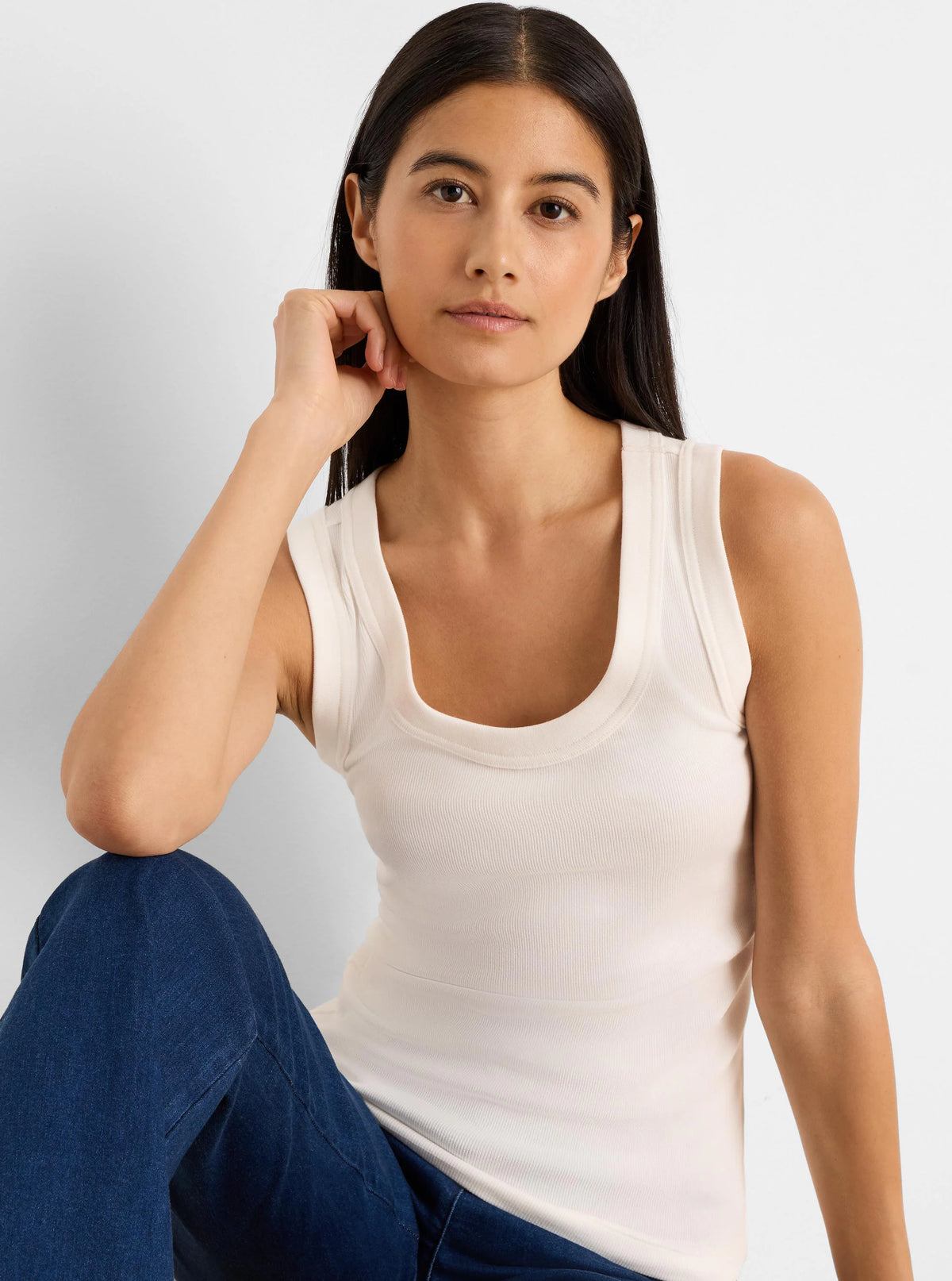 Ecru ribbed knit scoop neck tank top.