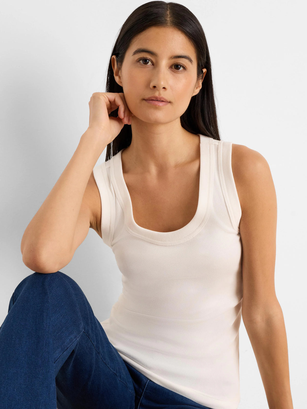 Ecru ribbed knit scoop neck tank top.