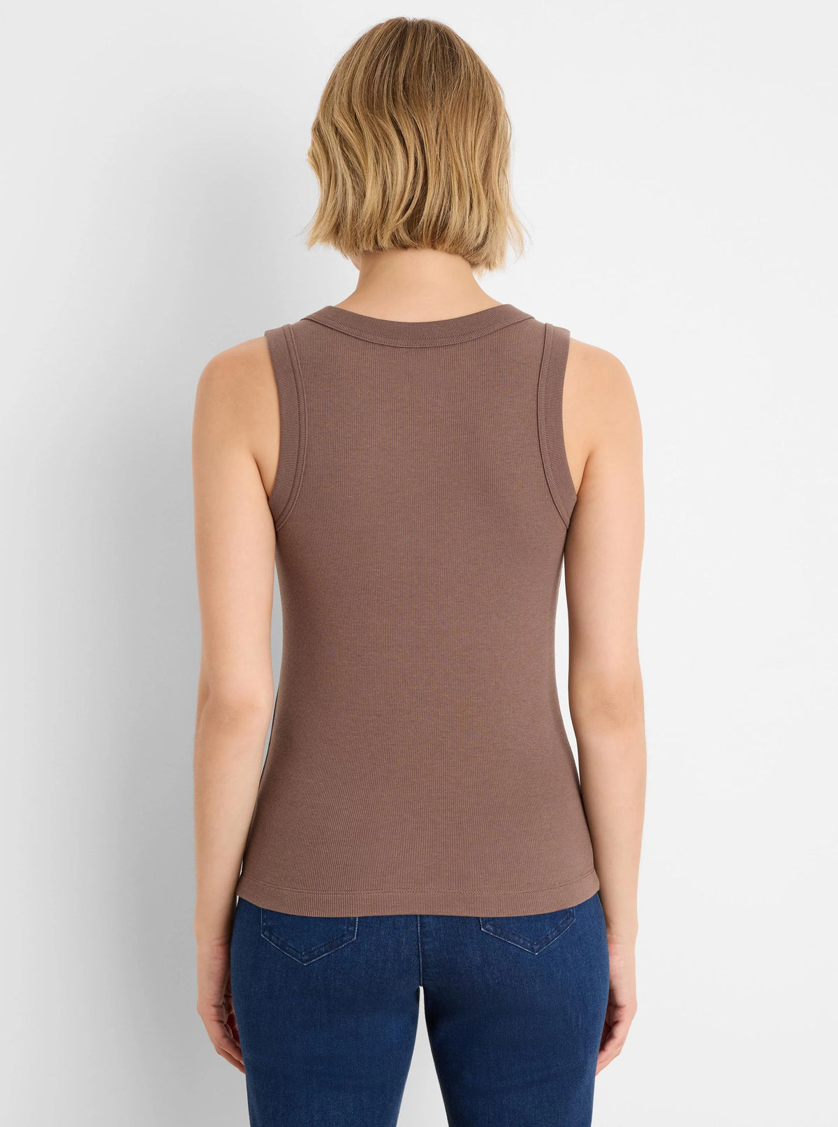 Back view of a model wearing a brown ribbed knit scoop tank.
