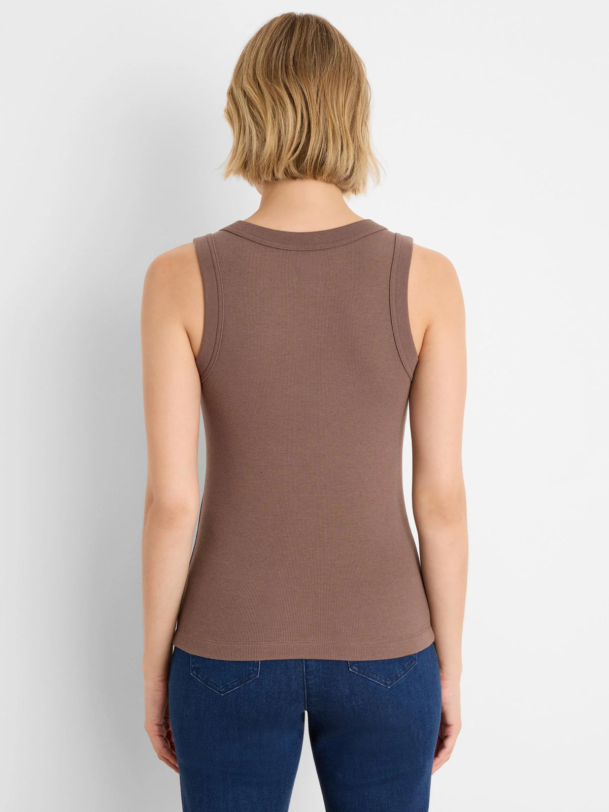 Back view of a model wearing a brown ribbed knit scoop tank.