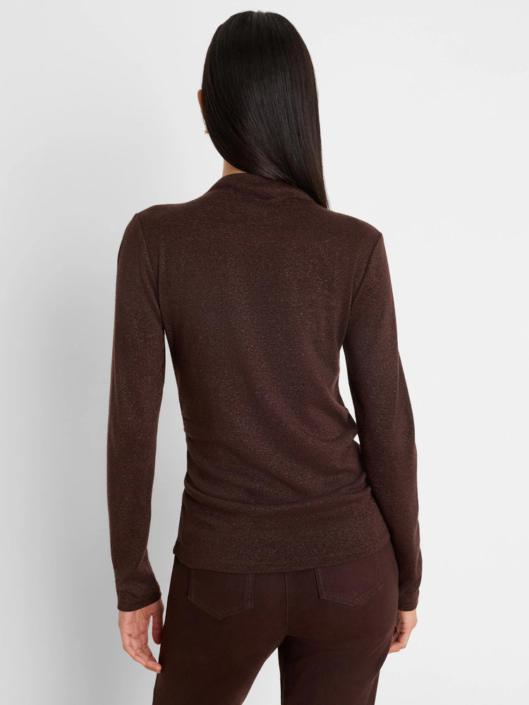 Dark brown shimmery long-sleeve top with a mock neck, fitted, shown from the back on a model.