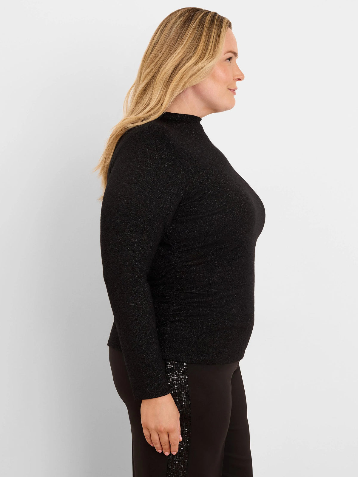 Black shimmering high-neck top with long sleeves and side ruching.