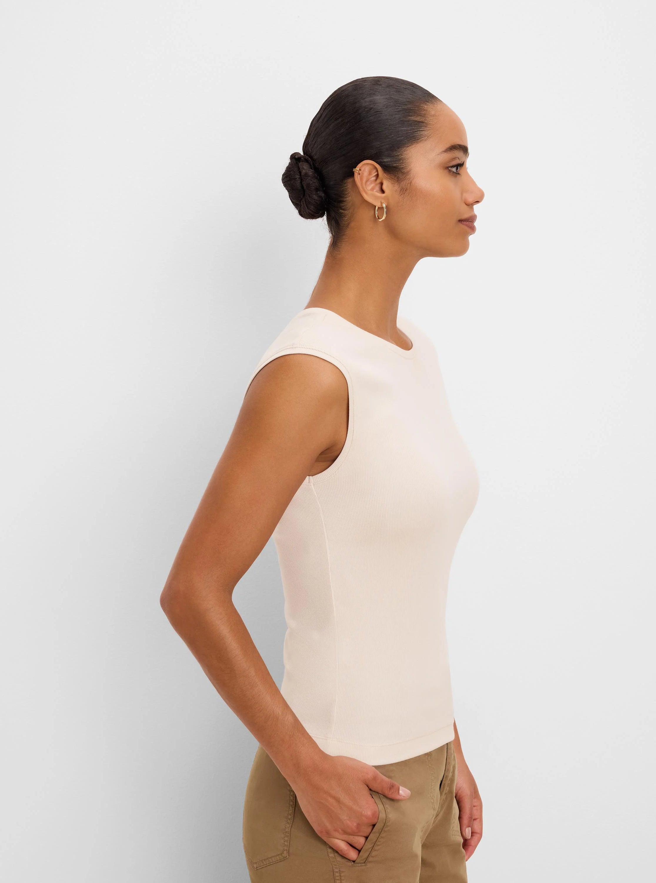 Light beige ribbed knit sleeveless tank top with a rounded neckline.