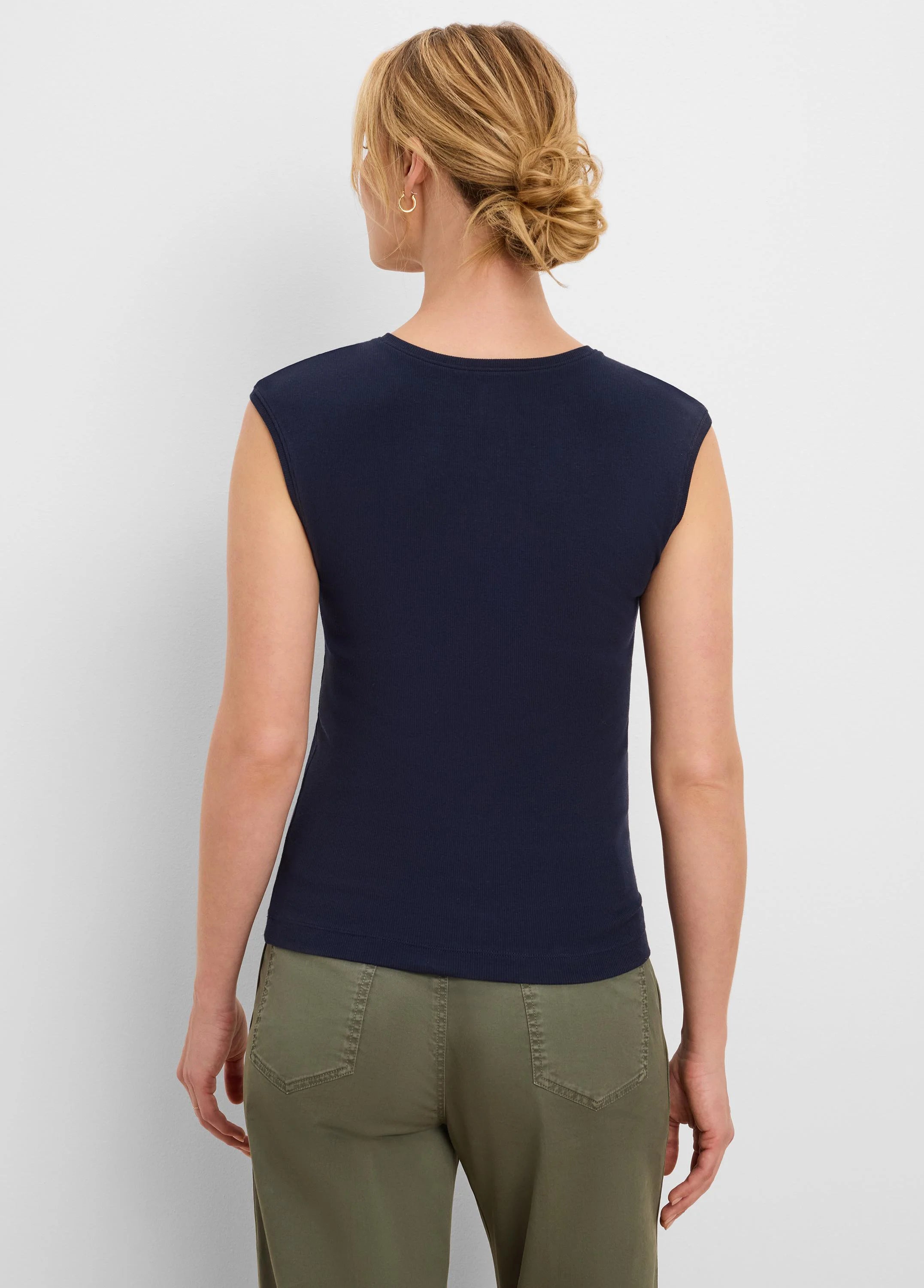 Back view of a woman wearing a navy blue, ribbed, sleeveless tank top with a round neck.