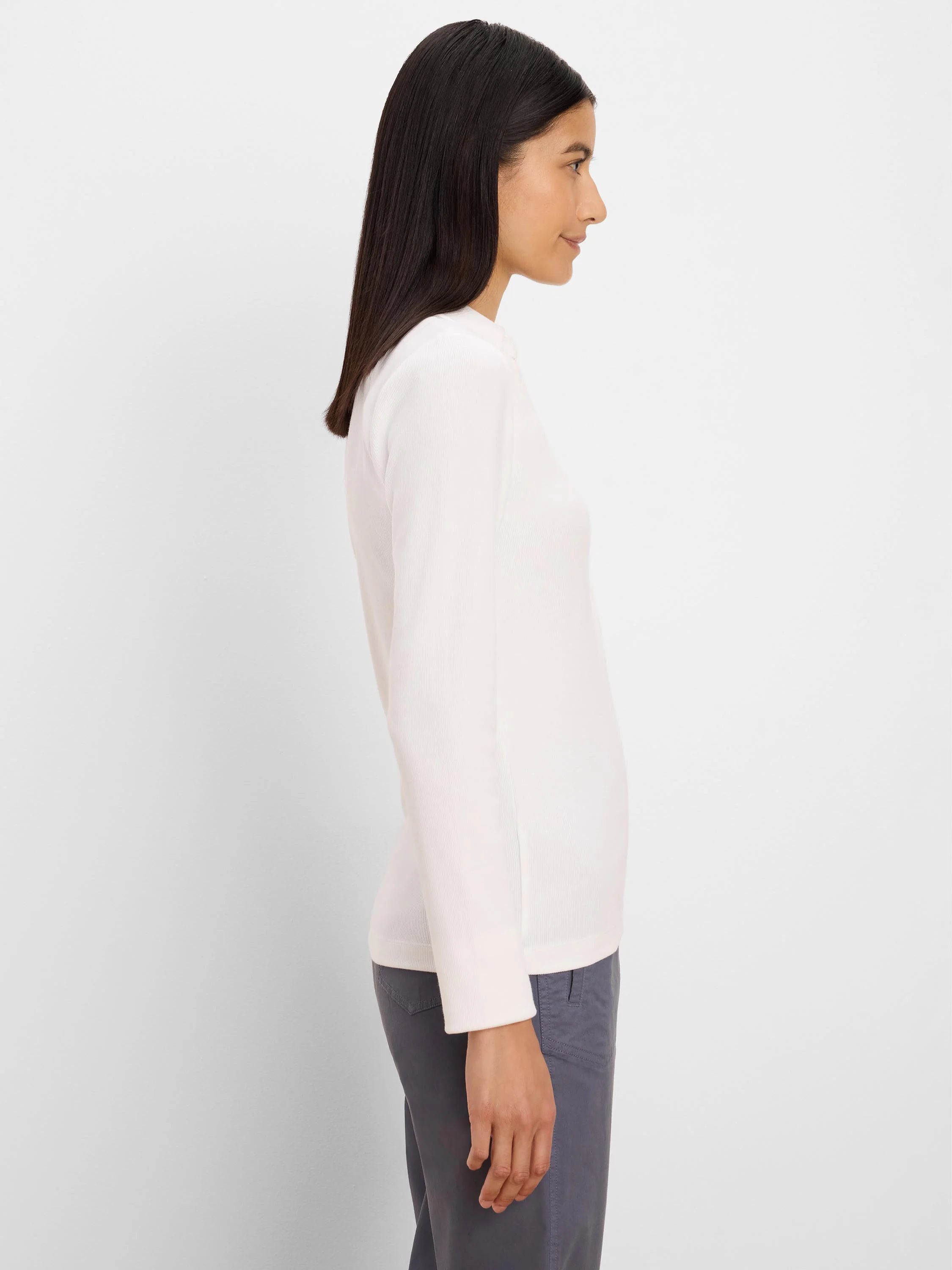Off-white long-sleeve ribbed knit polo on a model, shown in profile.