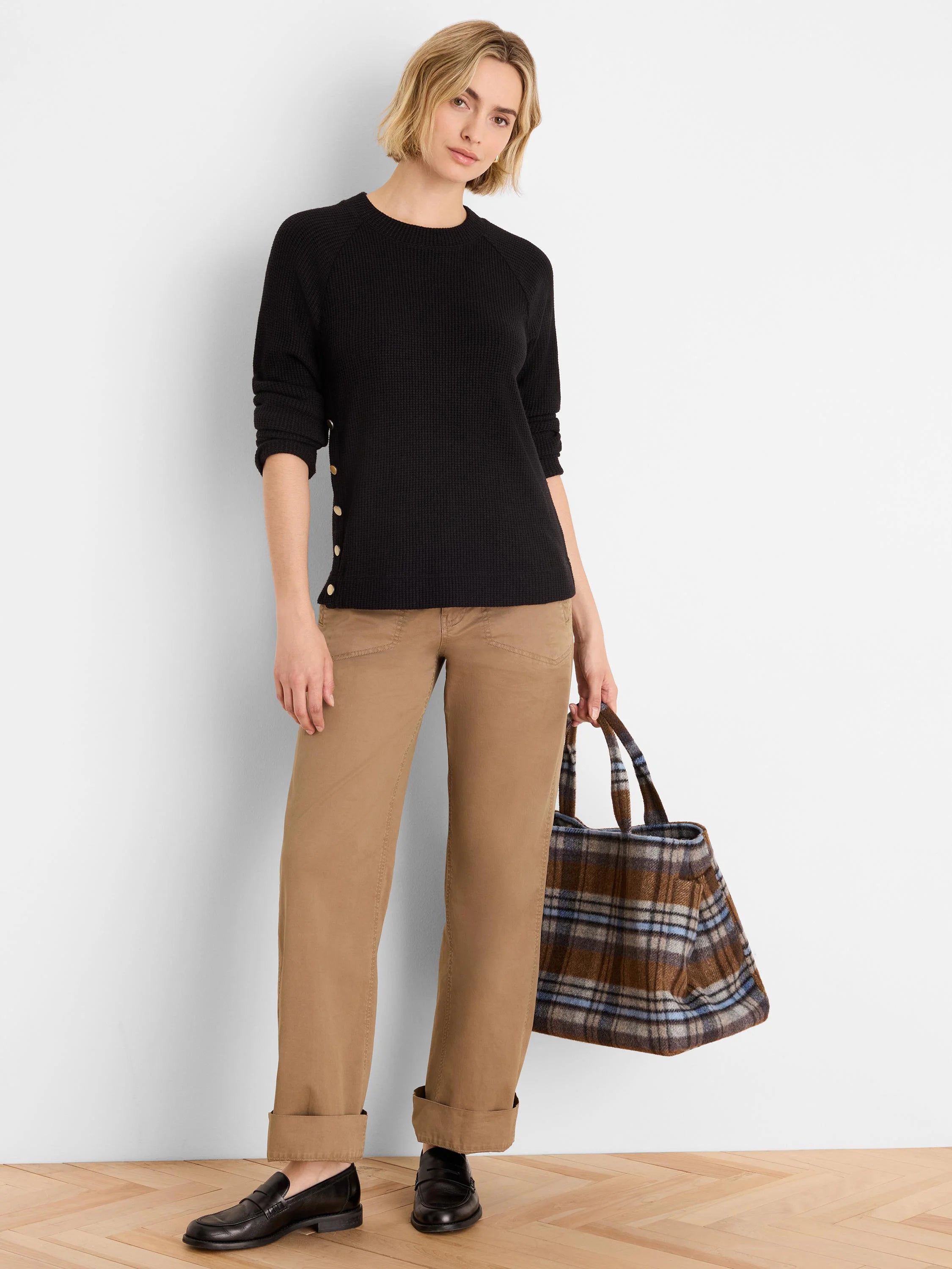 Black waffle knit top with long raglan sleeves and gold buttons down the left side.
