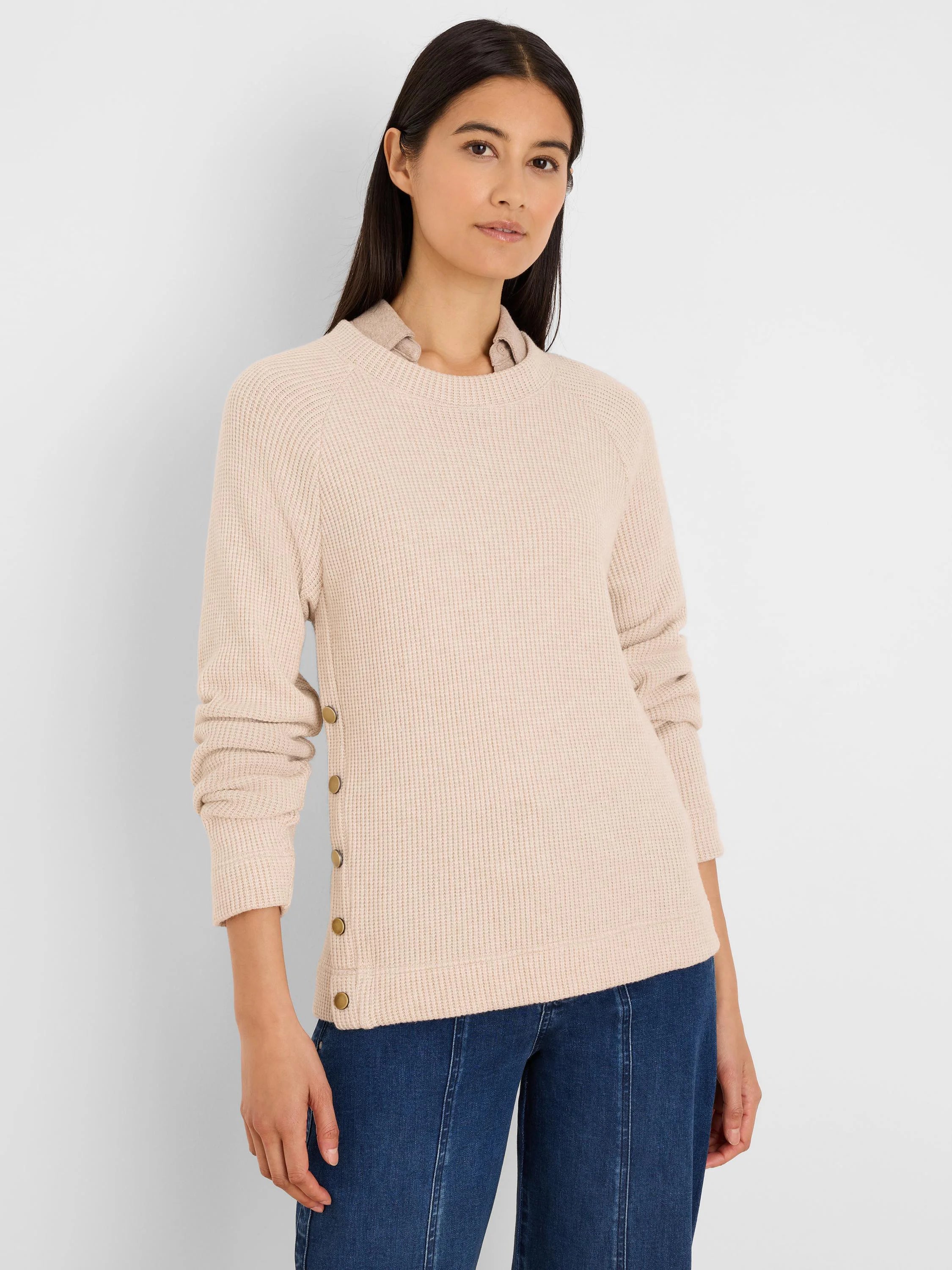 Light beige waffle knit top with long sleeves and gold buttons down the left side.
