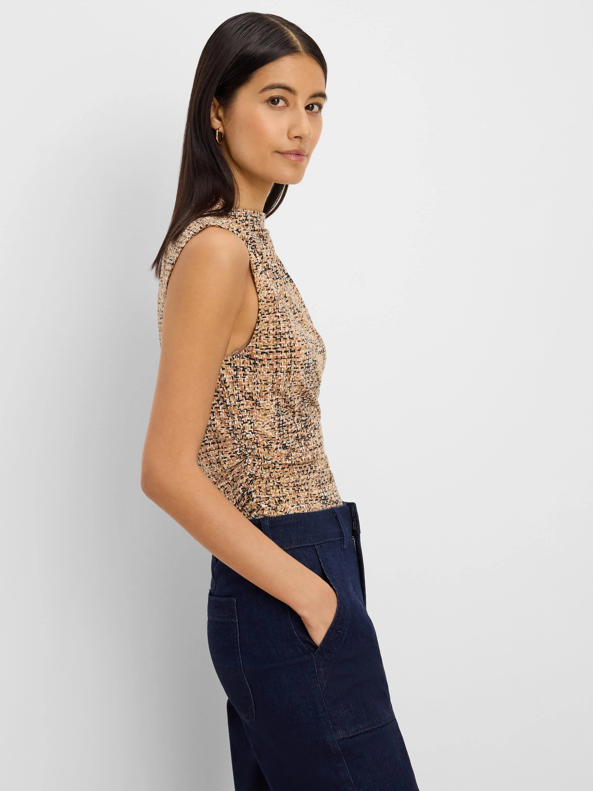 Sleeveless, high-neck tweed knit tank. Multi-color print with beige, black, and rust threads.