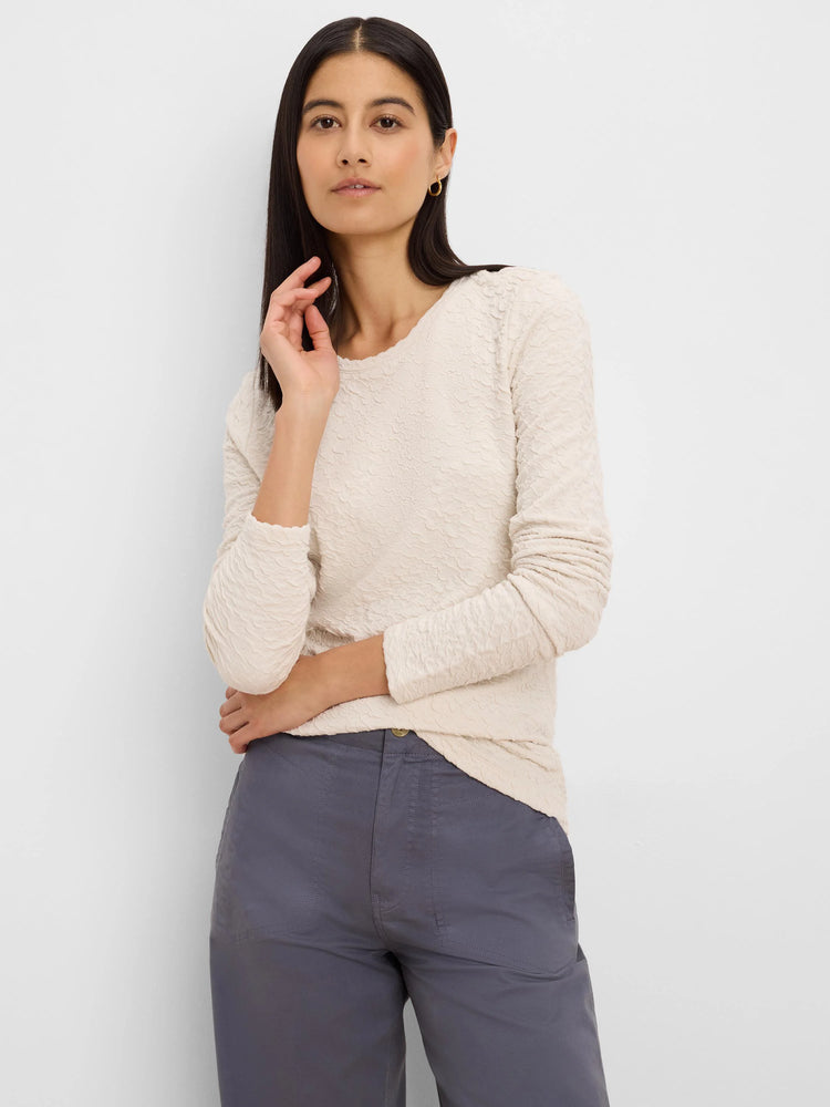 Light beige long-sleeve top with a distinct crinkle knit texture, shown on a model.