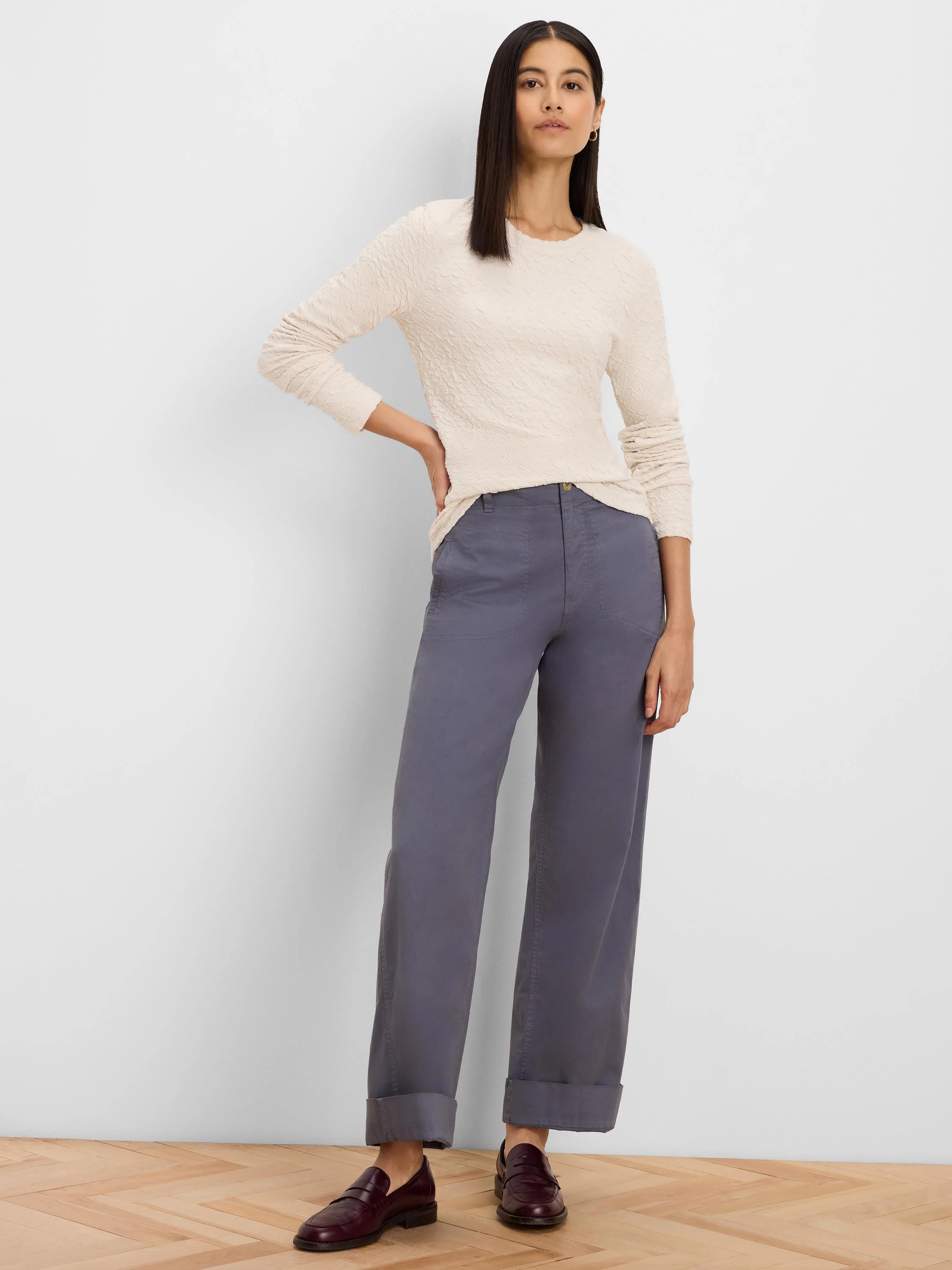 Cream long-sleeve top with an irregular, bumpy textured surface.