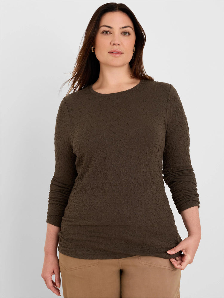 Dark olive brown crinkle knit top with long sleeves and a distinct wavy texture, modeled.