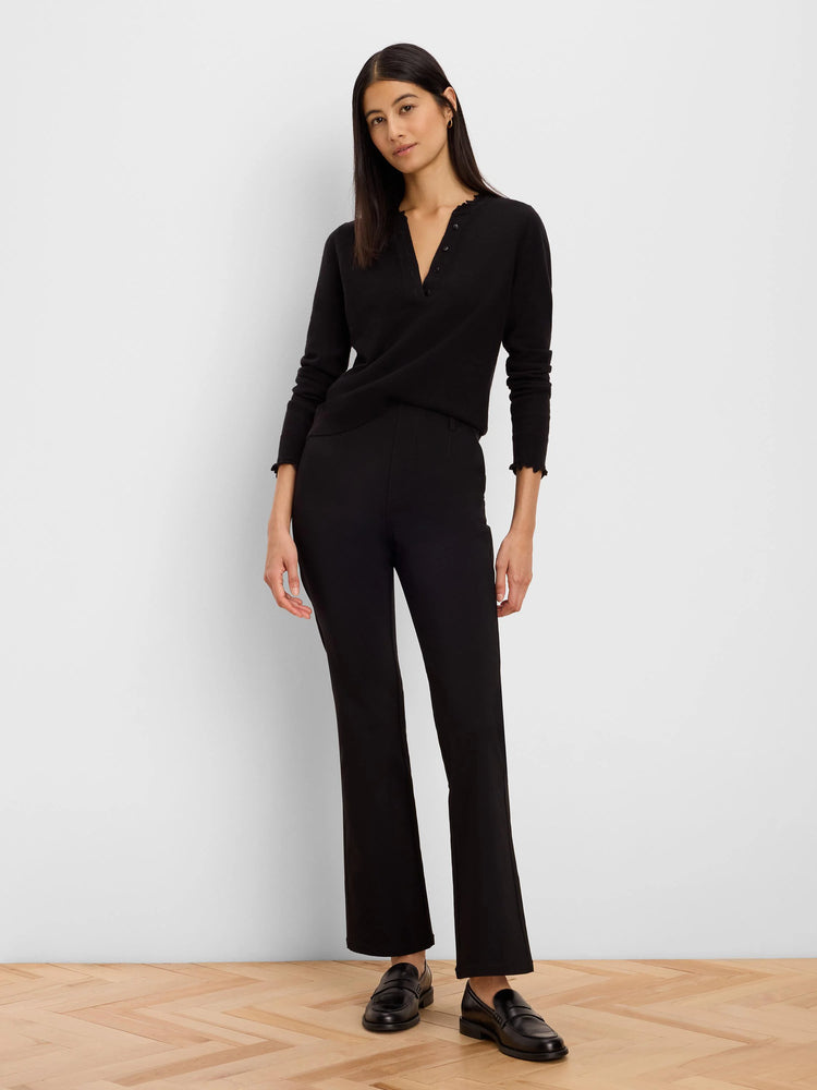 Black Henley sweater with ruffled neckline and cuffs.