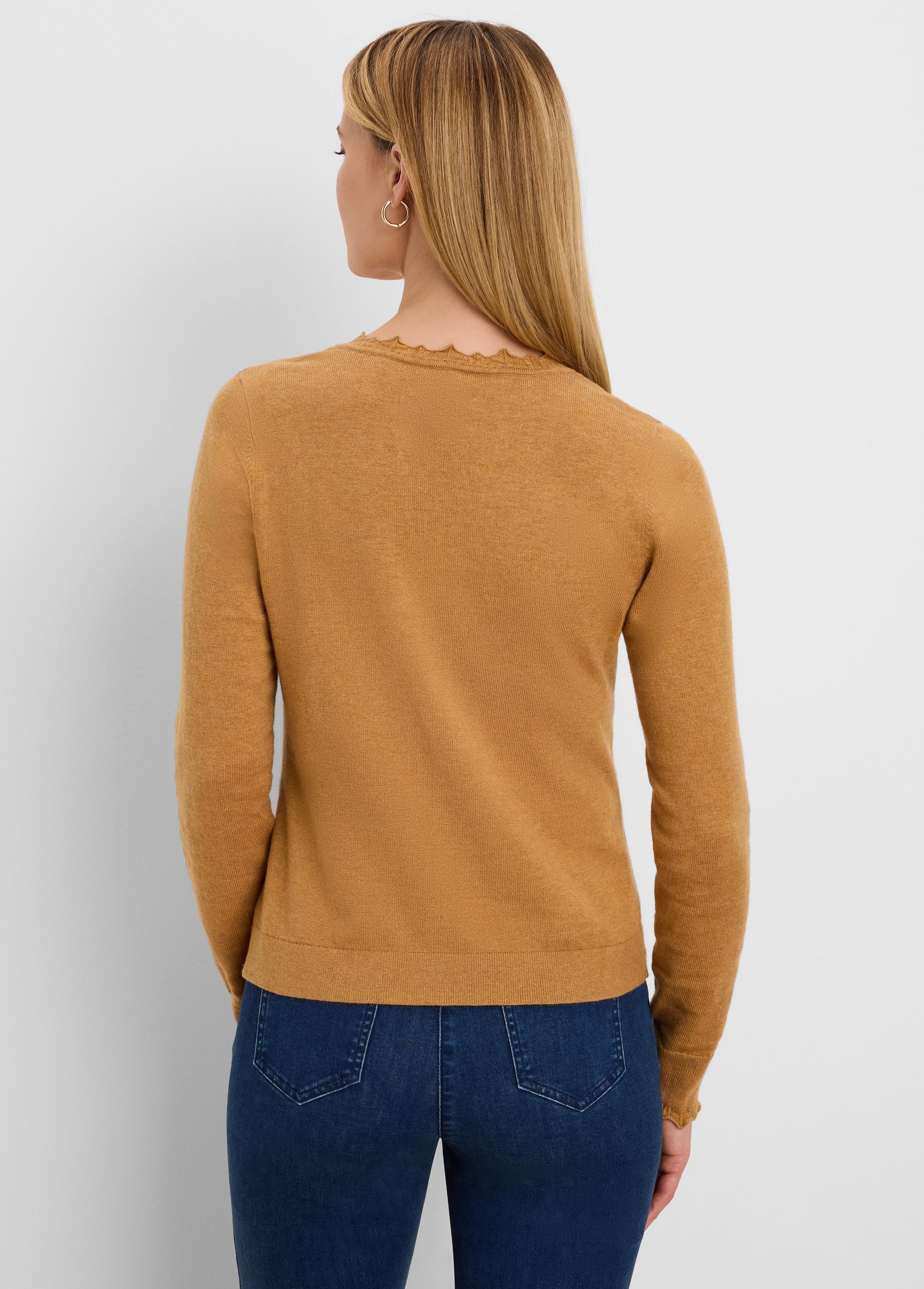 Camel long-sleeve knit sweater with a scalloped neckline, seen from the back.