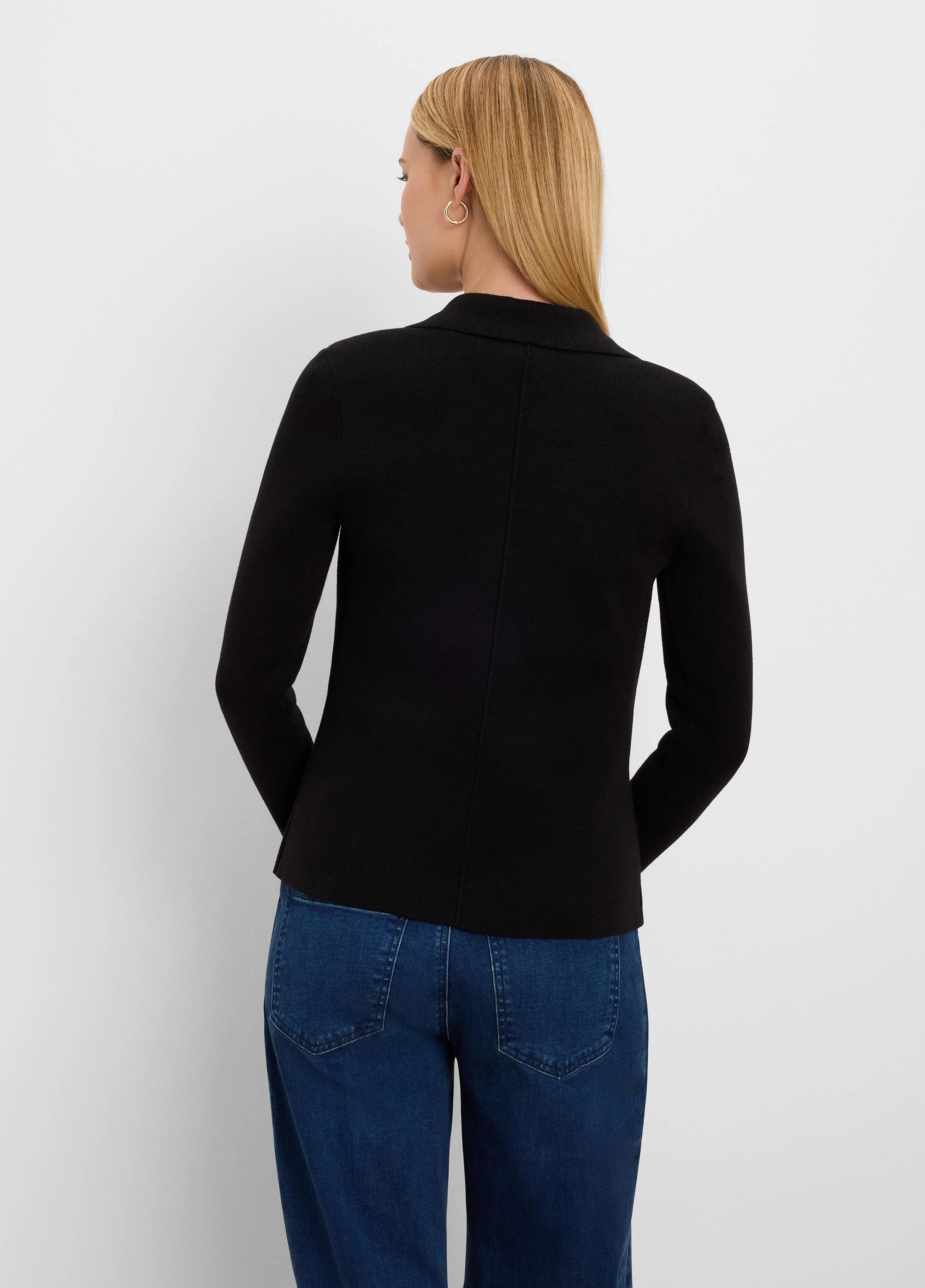 Black blazer, back view on model. Features ribbed knit texture, long sleeves, and a lapel collar.