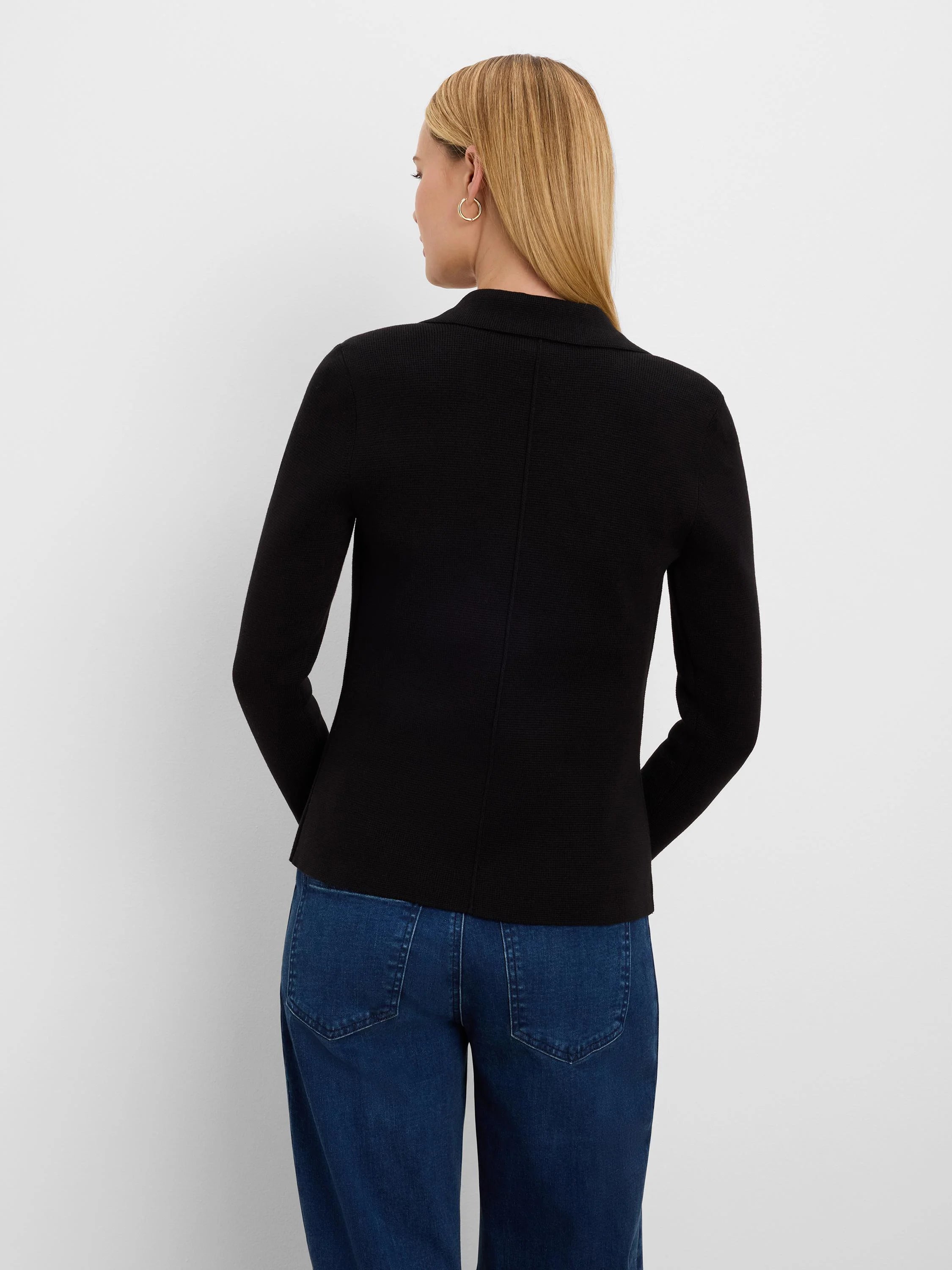 Black blazer, back view on model. Features ribbed knit texture, long sleeves, and a lapel collar.