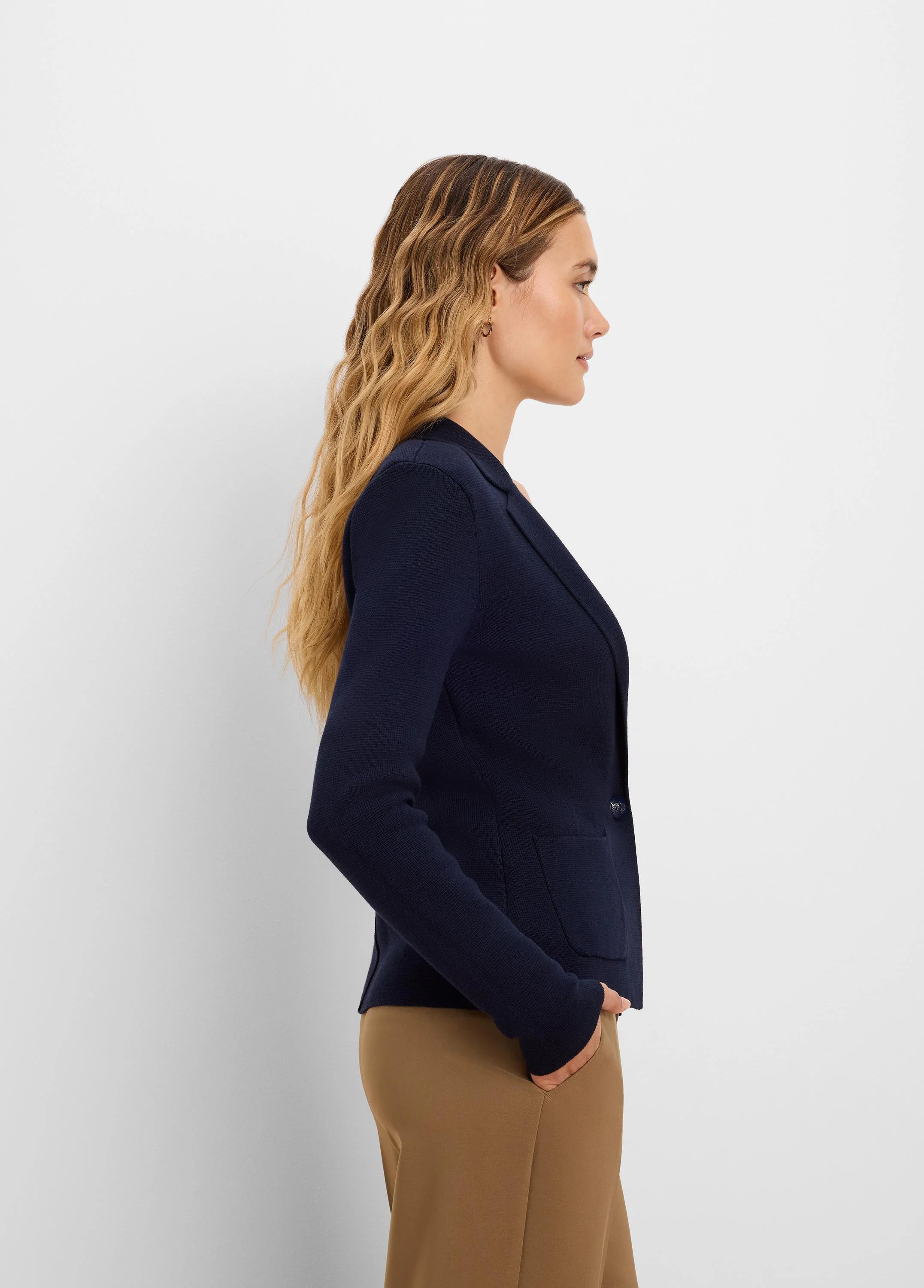 Navy knit tailored blazer with lapels, a single button closure, and two front patch pockets.