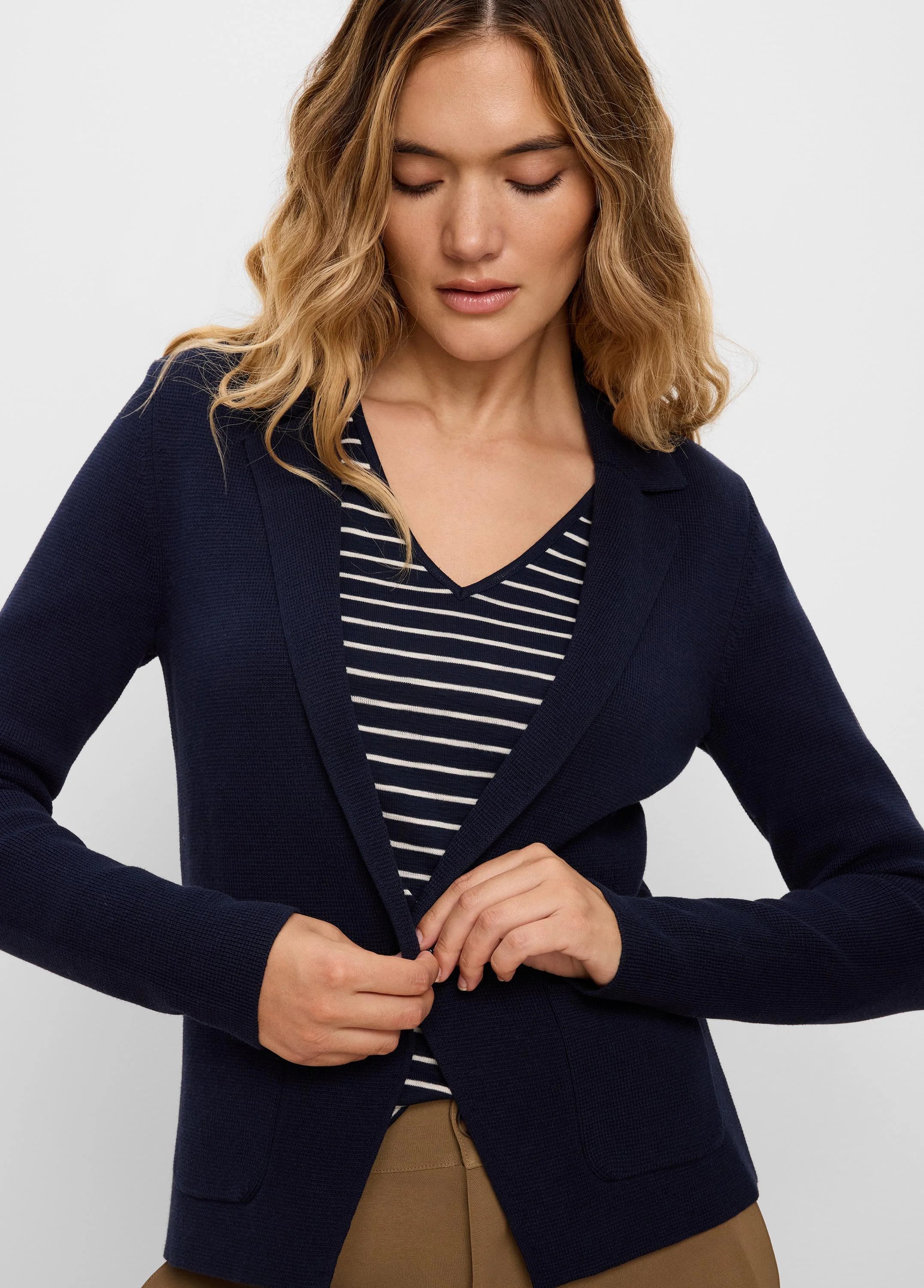 Navy textured knit blazer with lapels, a single button closure, and two front patch pockets.