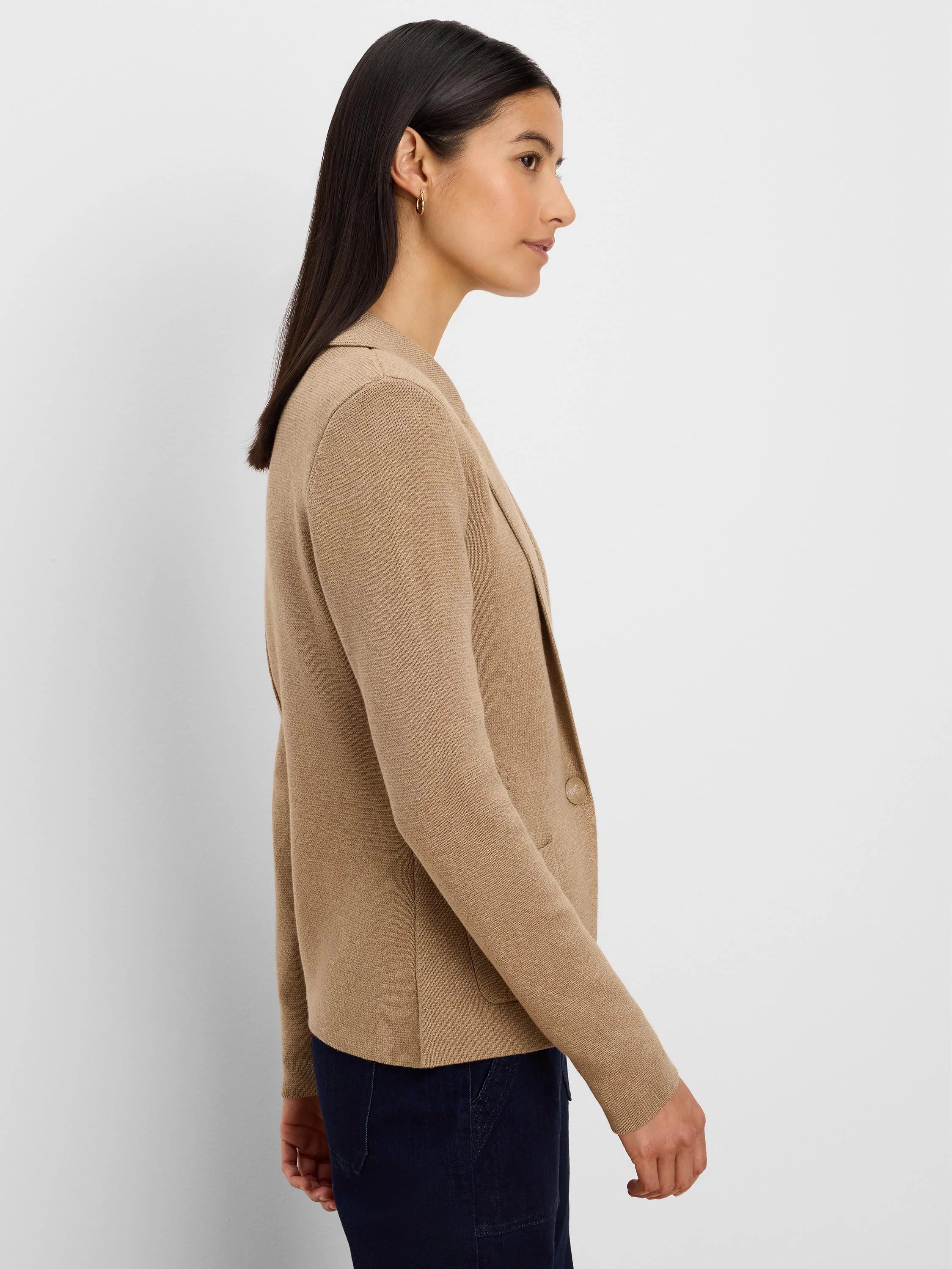 Camel knit blazer with notched lapels, one button, and a patch pocket, worn by a woman.