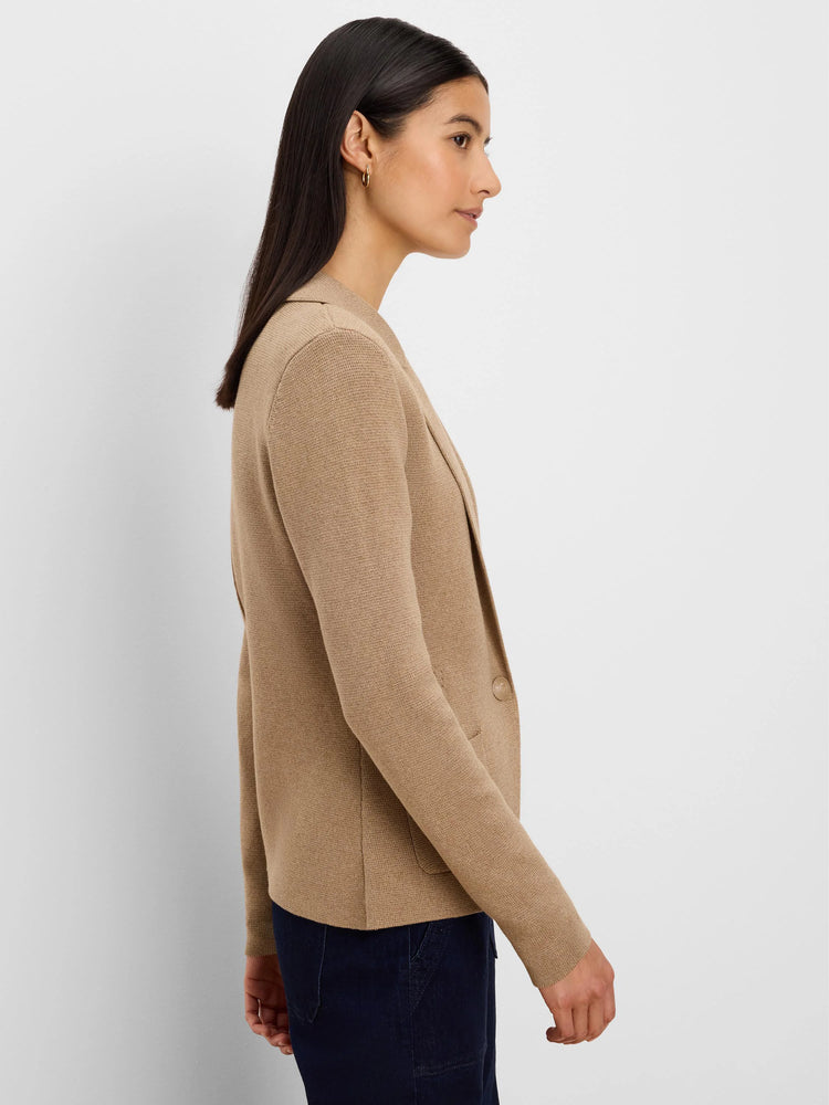 Camel knit blazer with notched lapels, one button, and a patch pocket, worn by a woman.