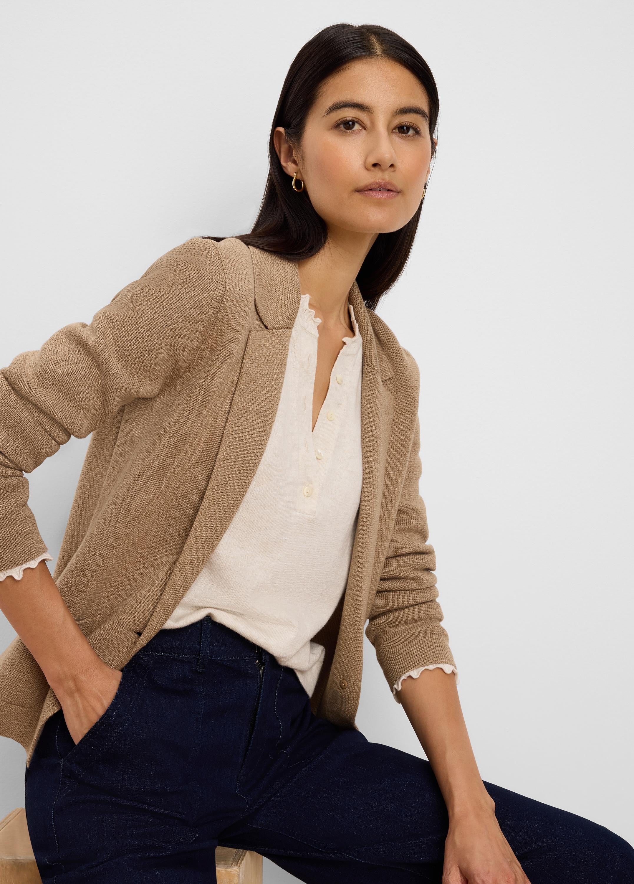 Tan knit blazer with tailored lapels, visible textured weave, shown open.