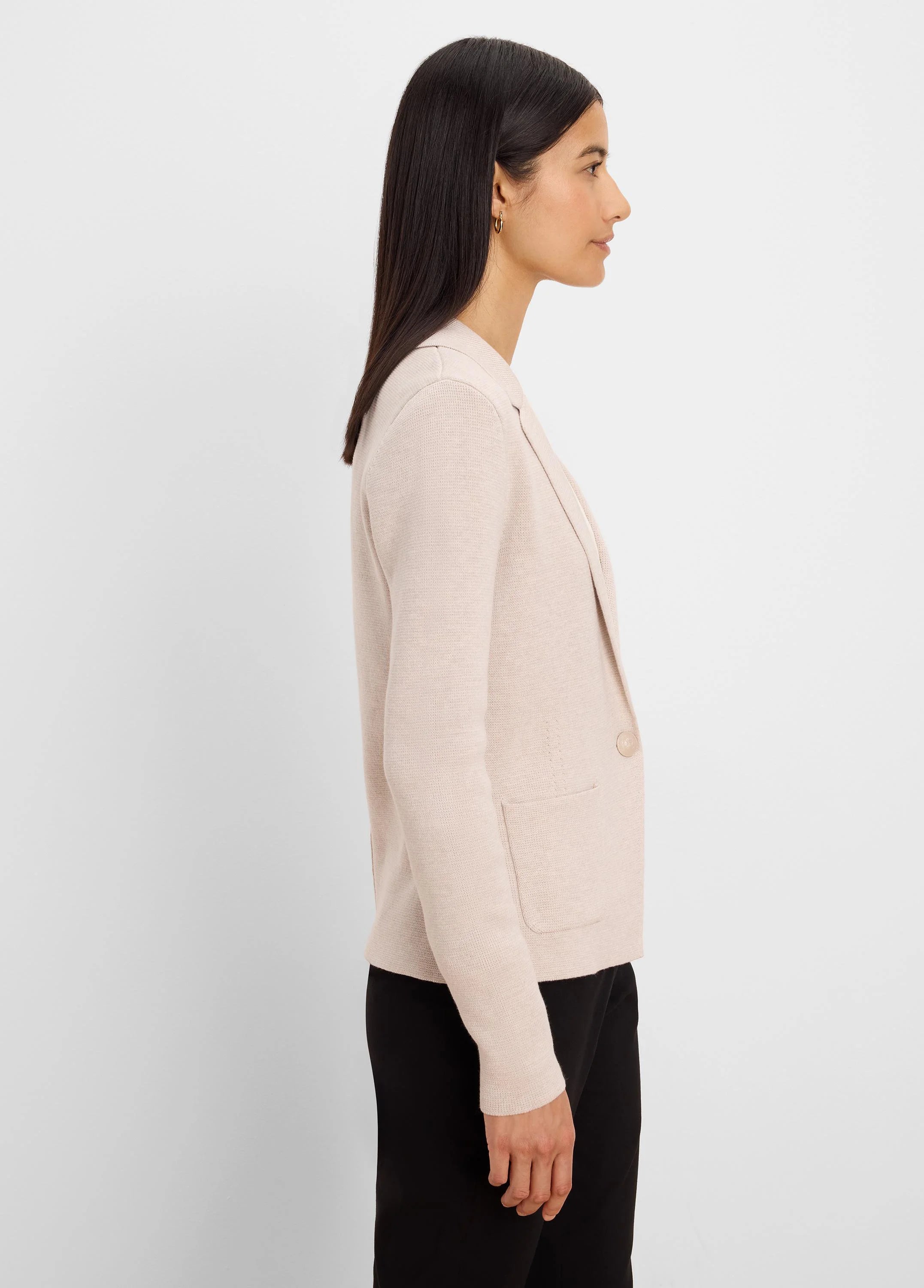 Light pink knit blazer with notched lapels, single light brown button, and two patch pockets.