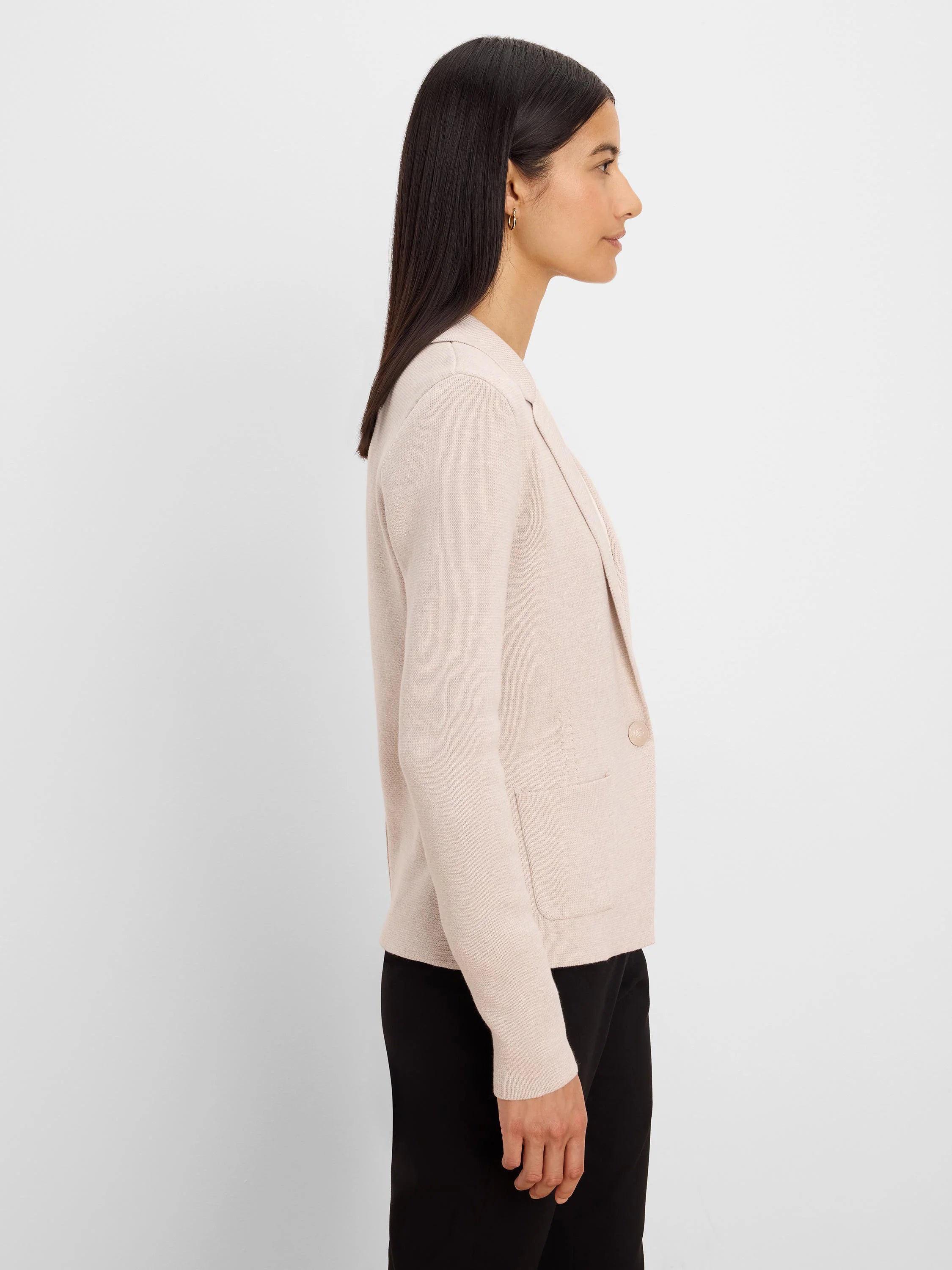 Light pink knit blazer with notched lapels, single light brown button, and two patch pockets.