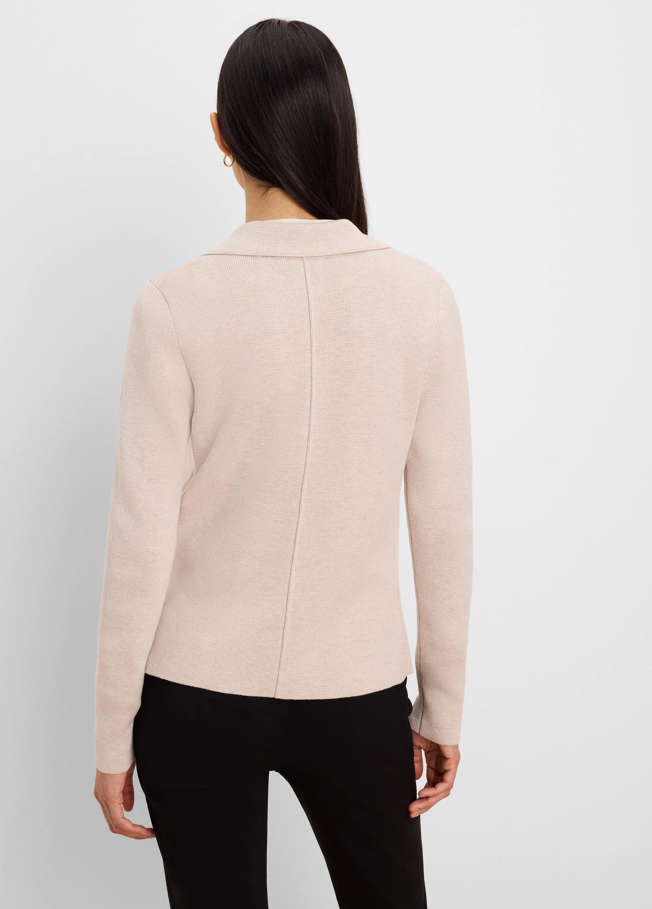 Light beige knit blazer, back view. Shows tailored collar and vertical back seam.