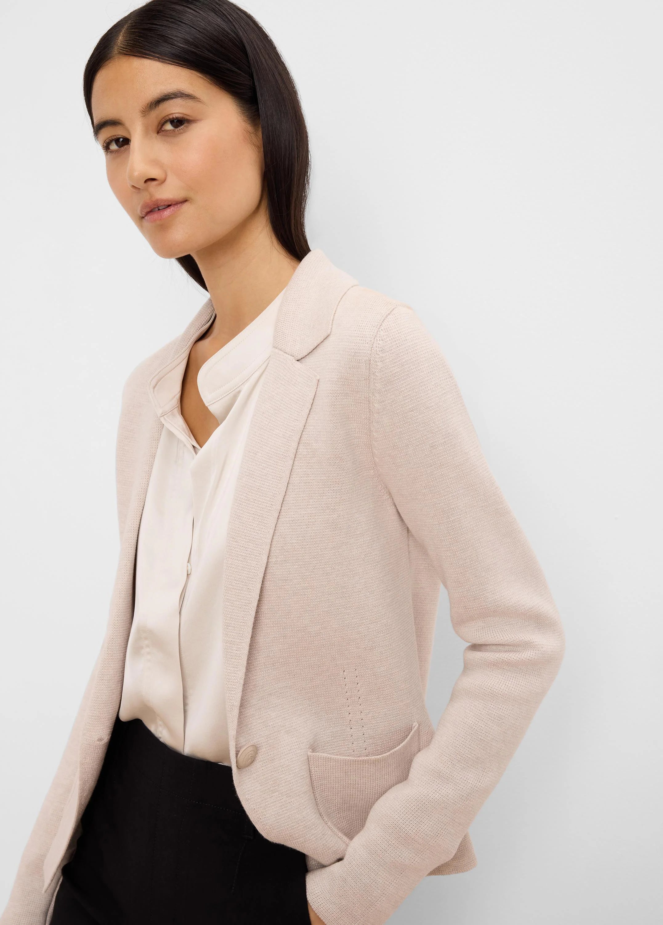 Blush knit blazer with notched lapels, a single button closure, and front patch pockets.