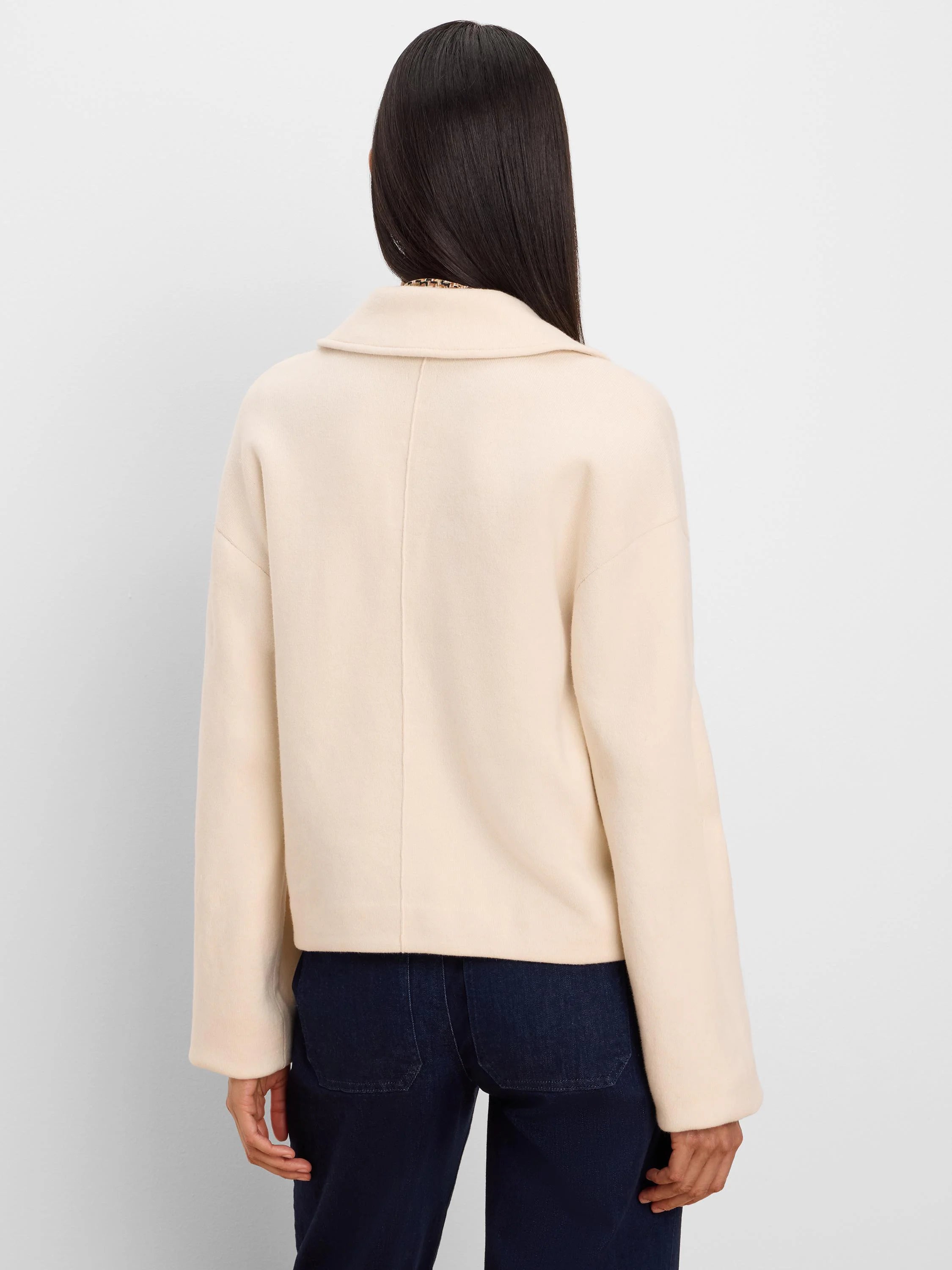 Cream knit jacket with a wide collar, relaxed fit, and long sleeves, shown from the back.