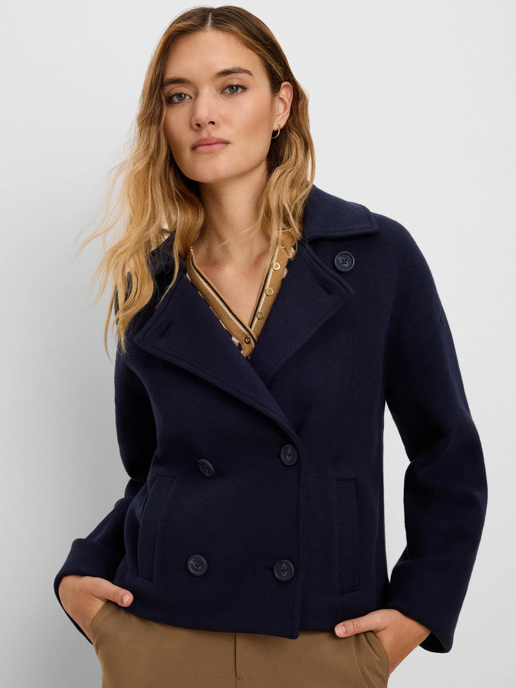 Navy blue knit jacket with double-breasted front, wide lapels, four visible buttons, and two patch pockets.