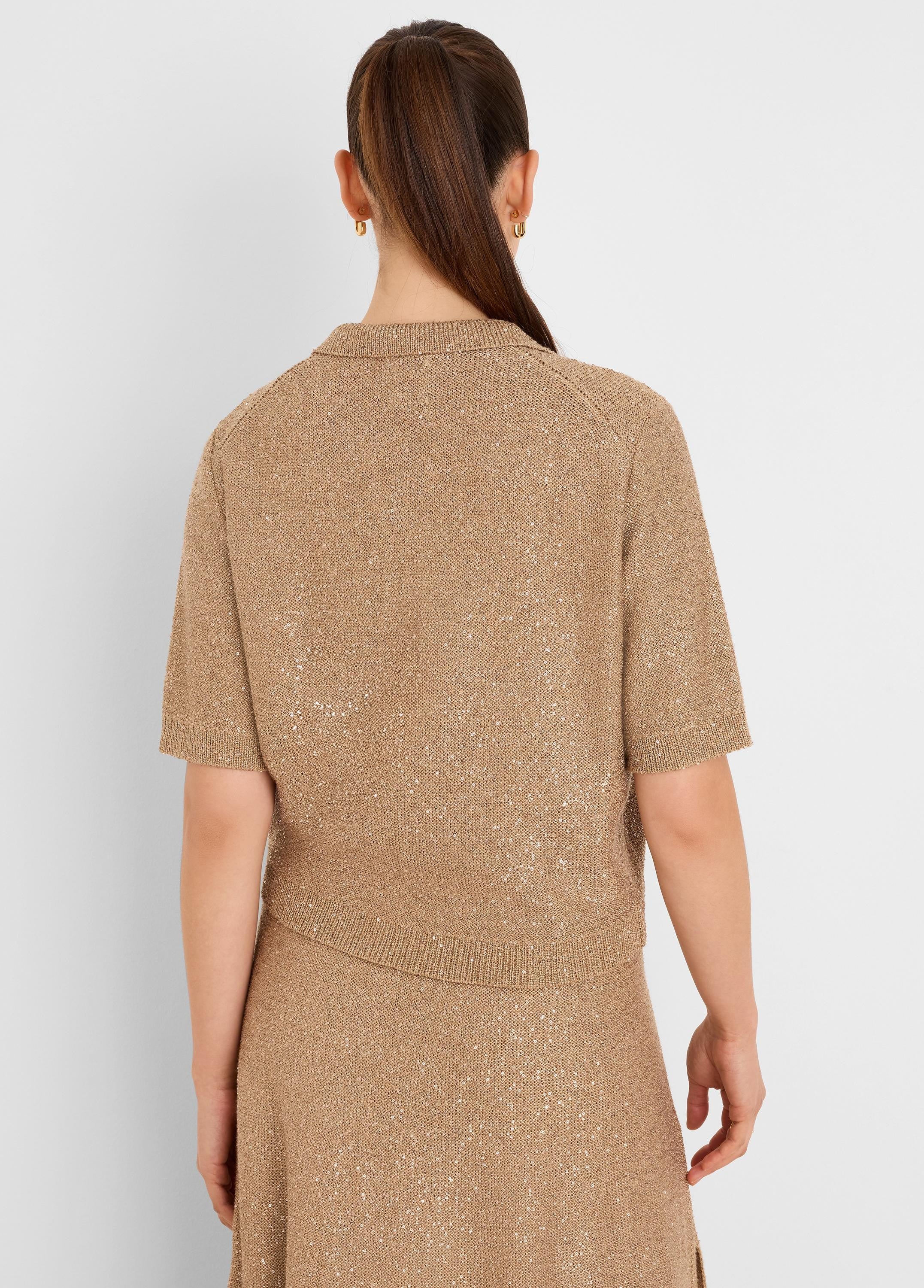 Tan sequin knit polo sweater with short sleeves and collar, featuring tiny shimmering sequins throughout. Back view.