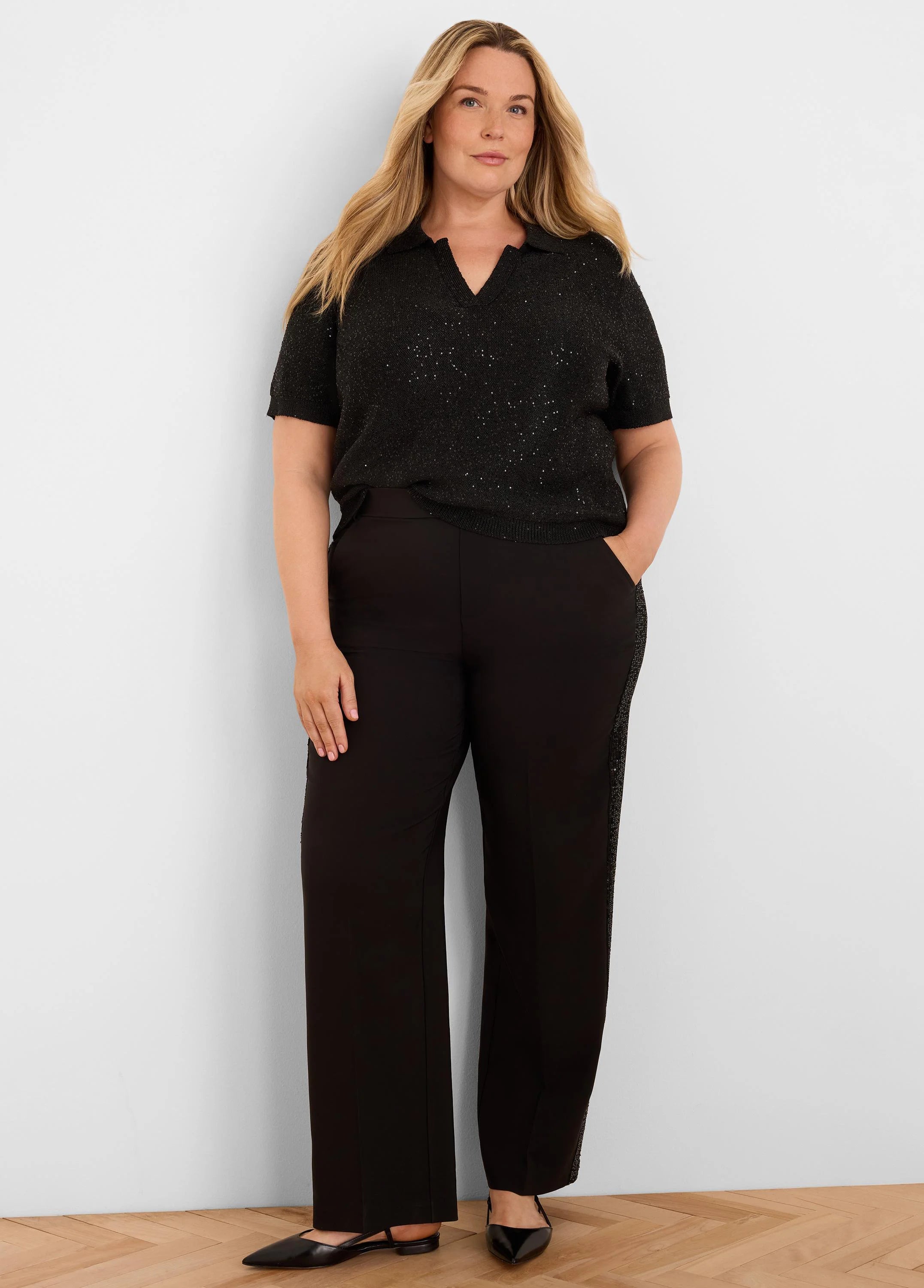 Black short-sleeve polo sweater with a V-neck, covered in subtle scattered sequins.