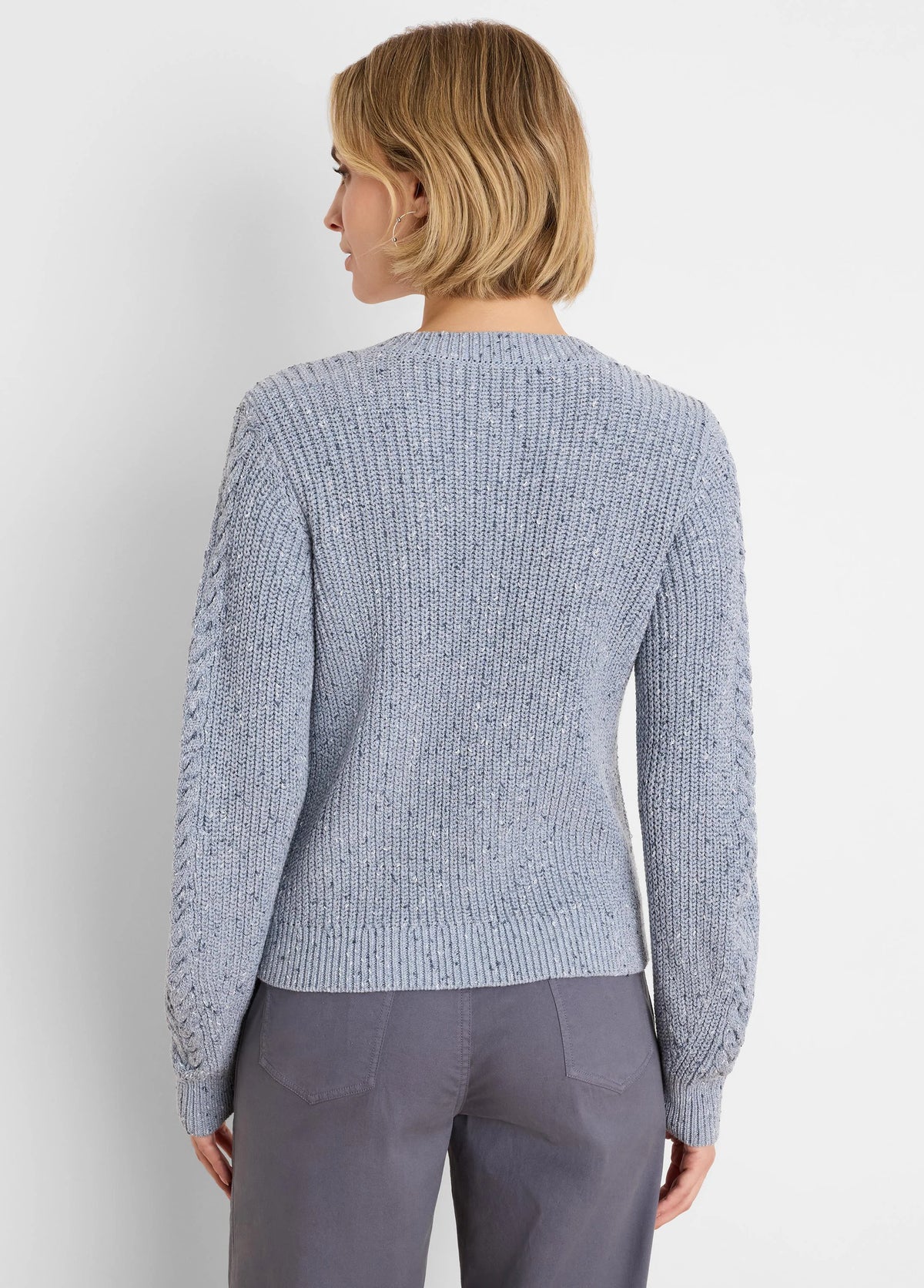 Light blue flecked shaker knit sweater with cable textured sleeves.