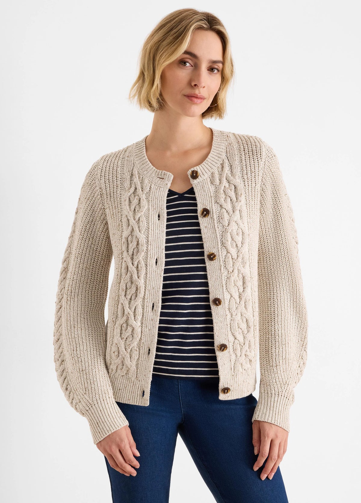 Oatmeal flecked cable knit cardigan with a round neck and brown buttons.