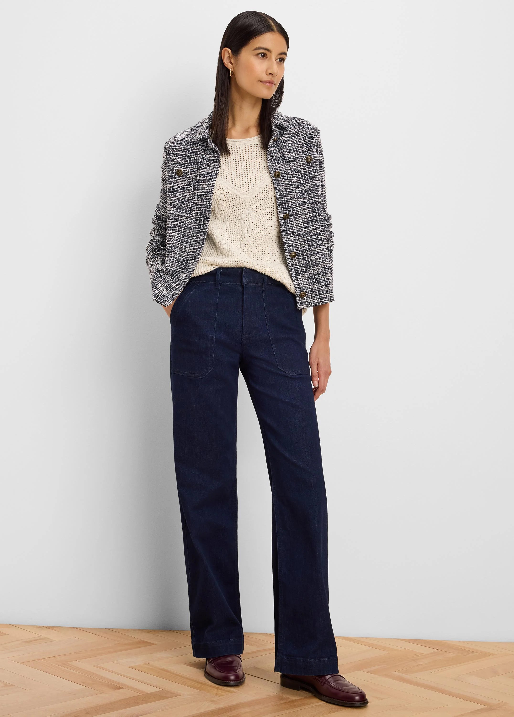 Cream V-neck sweater with a textured diamond stitch pattern.
