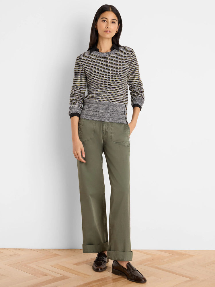 Marled knit sweater in grey, black, and tan pattern. Features ribbed cuffs, hem with decorative side buttons.