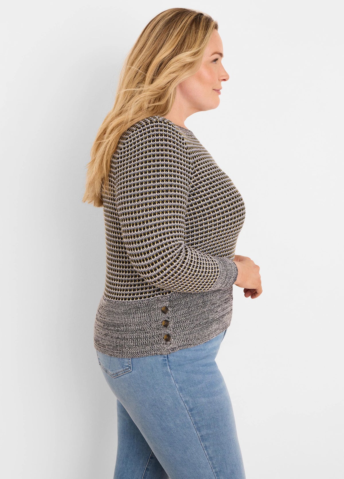 Marled grey & black knit sweater with small yellow-gold patterned upper. Features a darker hem with three side buttons.