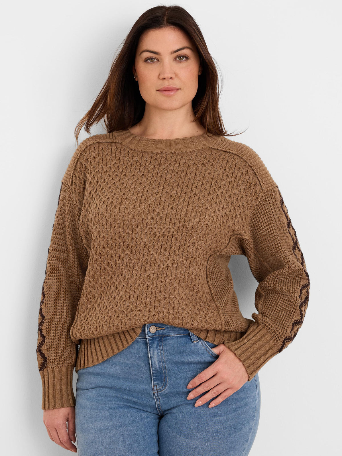 Tan brown textured knit sweater with a dark brown criss-cross pattern on the sleeves.