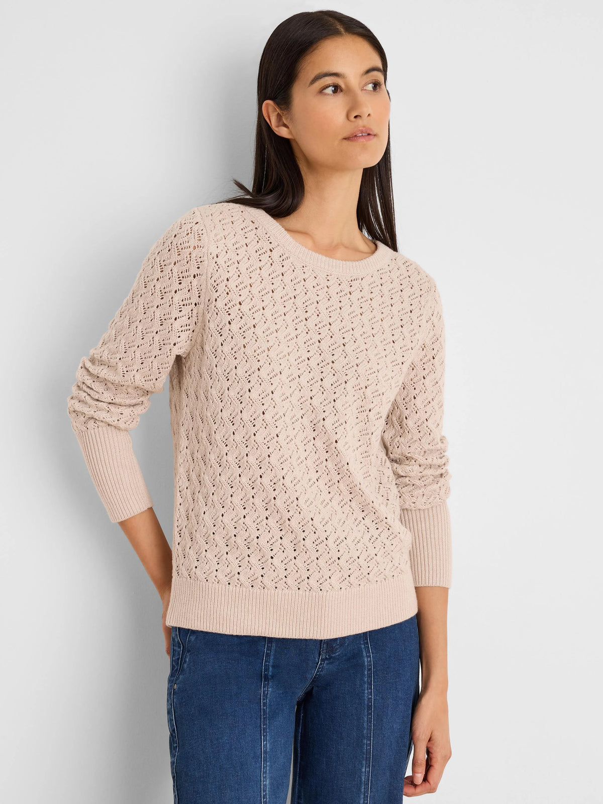 Light beige crew neck sweater with an open diamond knit pattern and ribbed neckline, cuffs, and hem.