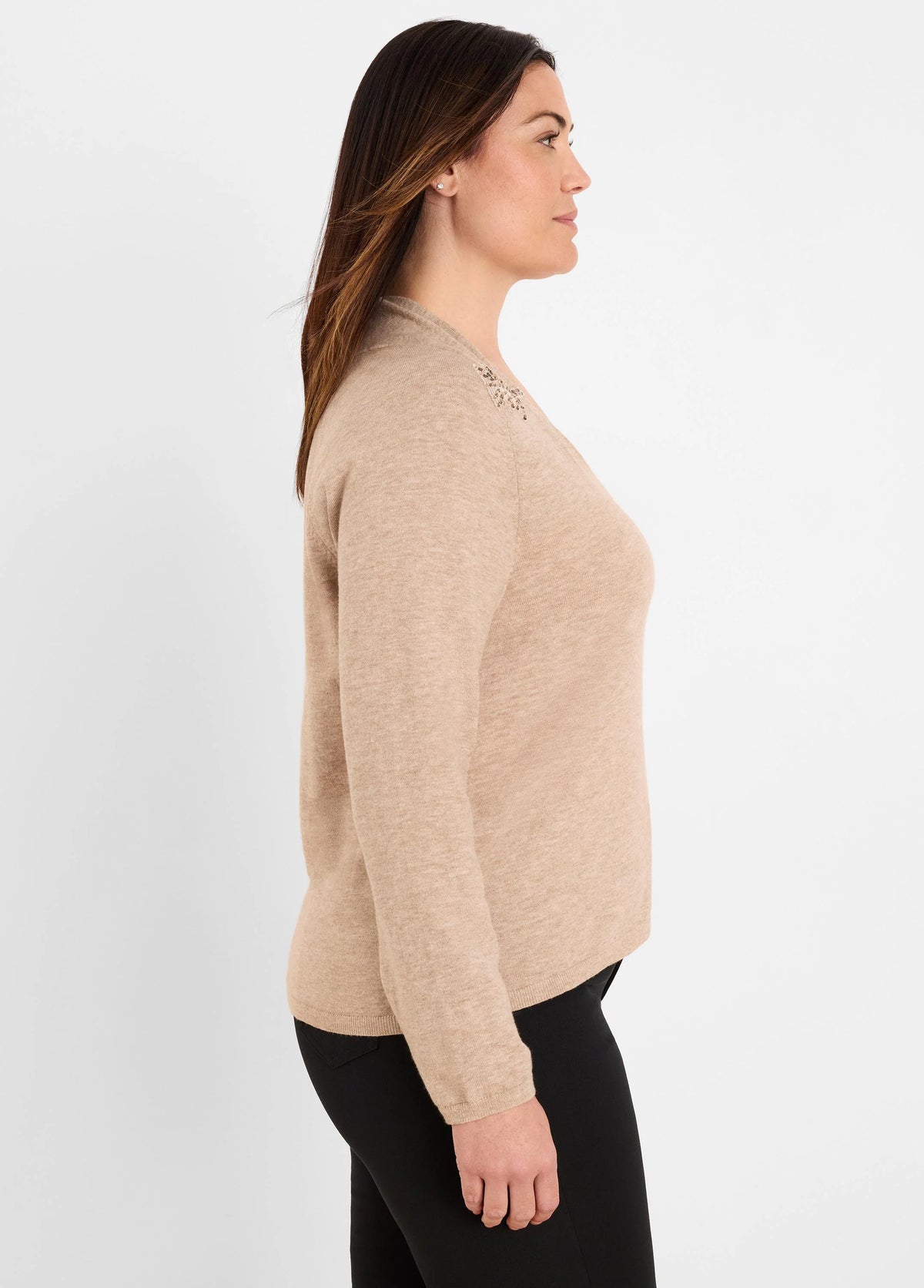 Tan long-sleeve sweater with sparkling embellishment on the shoulder.